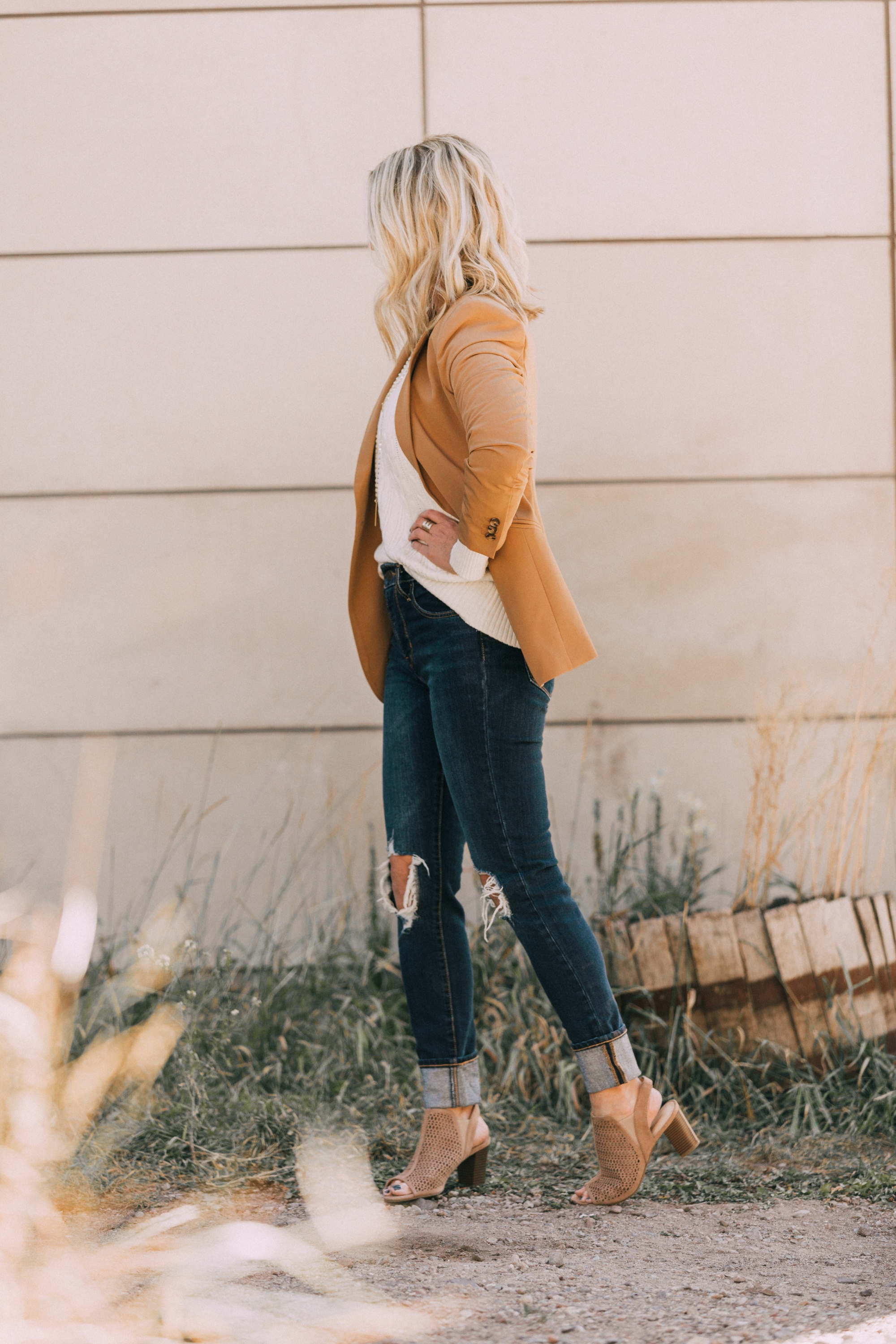 affordable camel colored blazer with blue jeans and white cable knit sweater open toe perforated nude booties