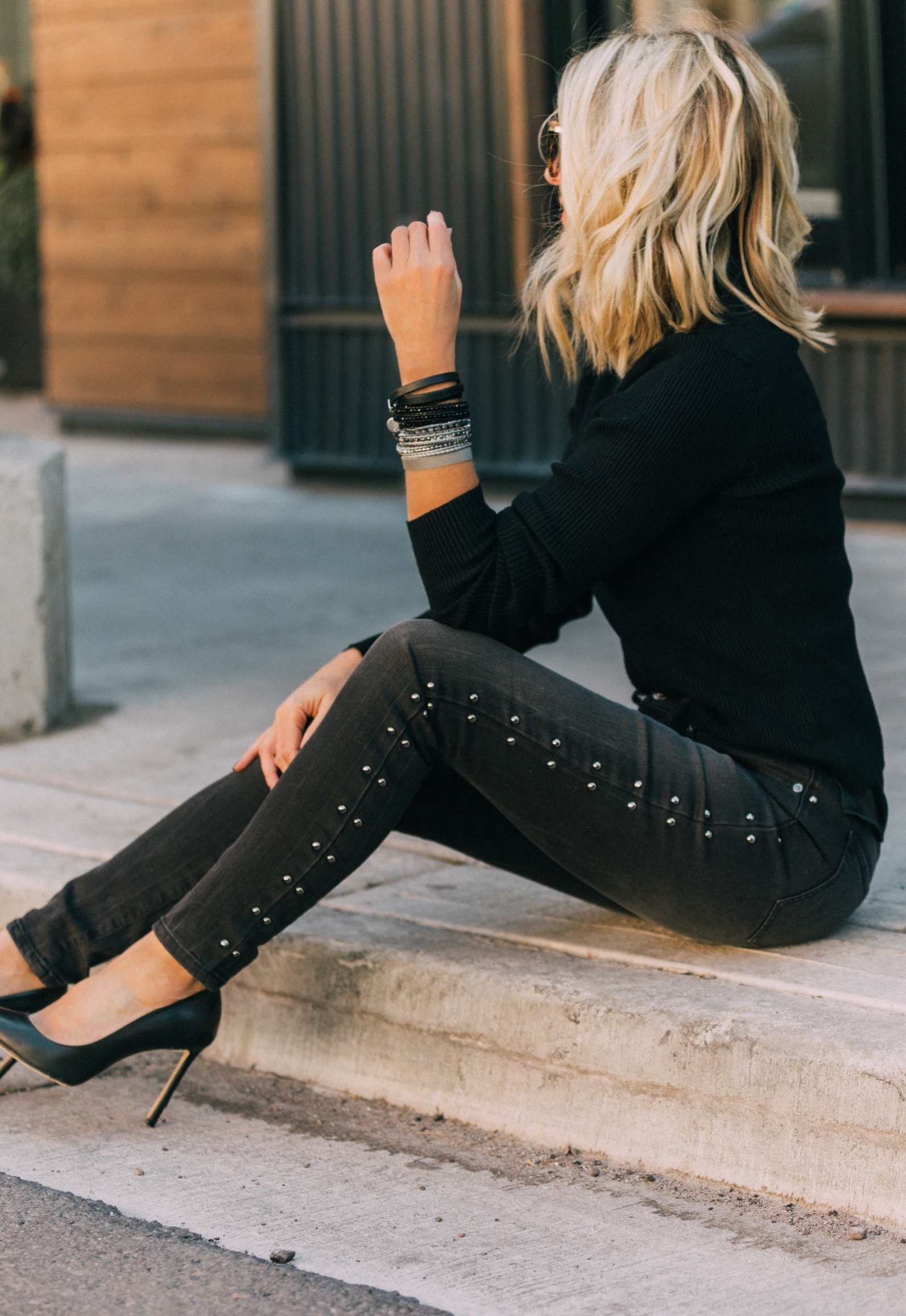 fashion blogger wearing victoria emerson wrap bracelets in all black outfit