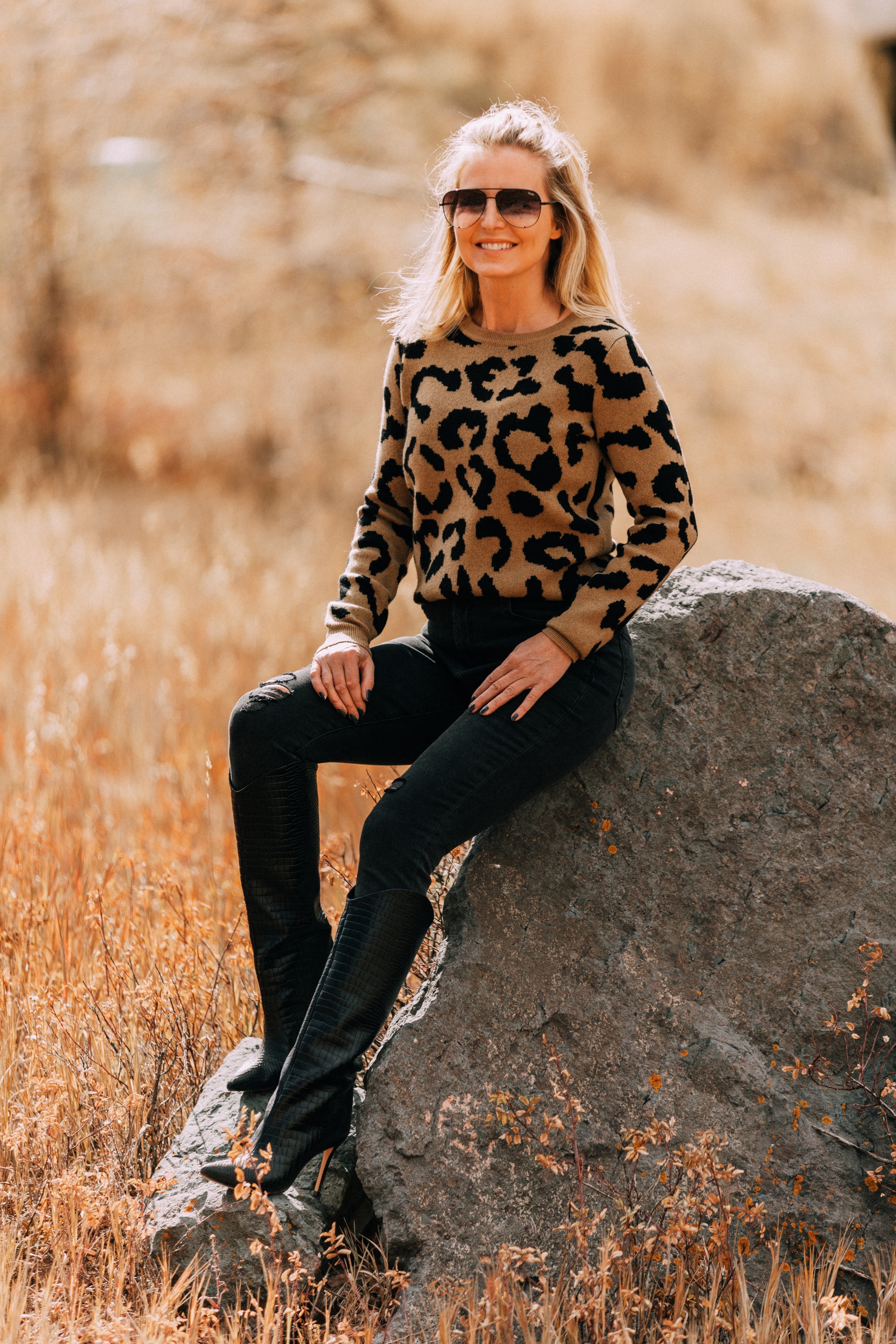madeleine thompson leopard print crewneck sweater outfit with Schutz Maryana black Snake-Embossed High-Heel Boots