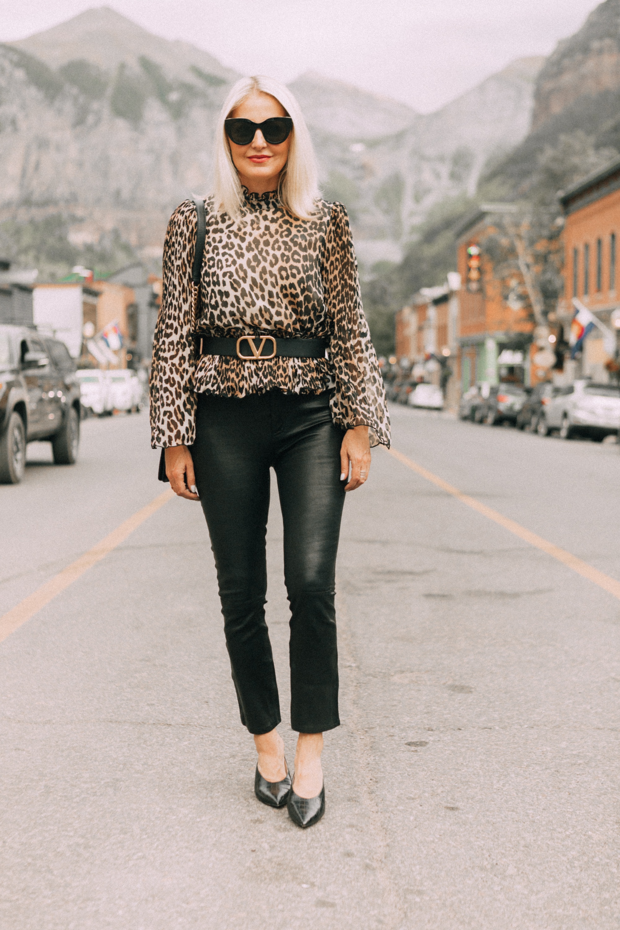 high neck blouse in leopard print by Ganni on fashion blogger erin busbee in Telluride colorado