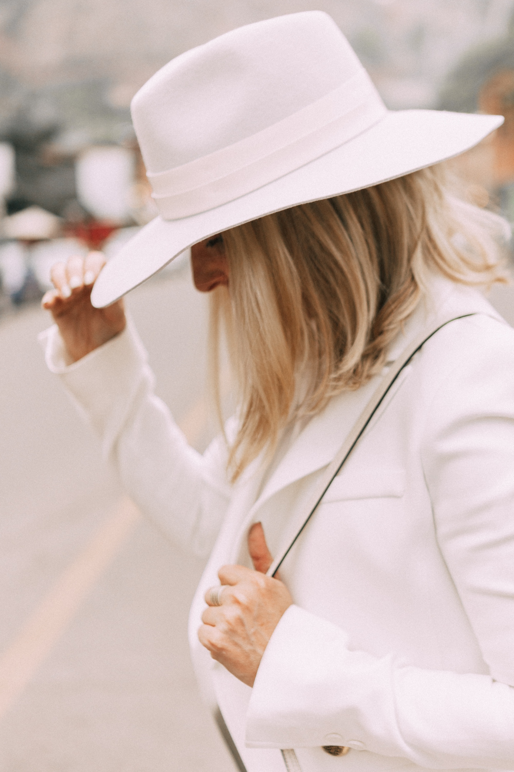 How To Wear Hats, Fashion blogger Erin Busbee of BusbeeStyle.com wearing a Janessa Leone white fedora with white Lioness blazer, white Tibi top, skinny jeans, white Chloe Nile bag, and white booties in Telluride, CO