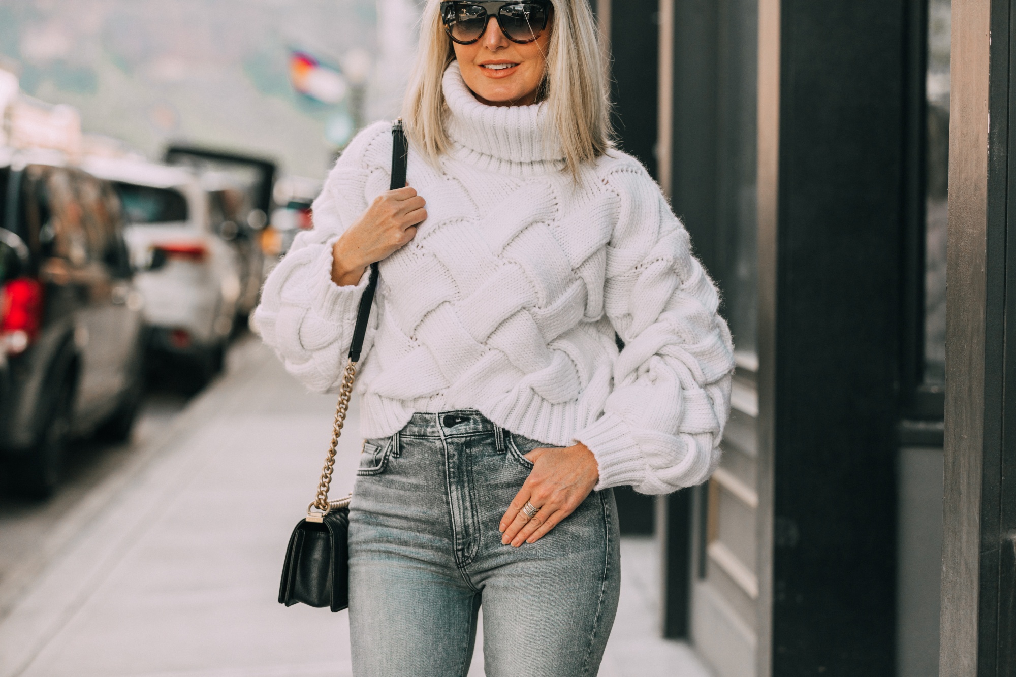 How To Style Dad Sneakers, Fashion blogger Erin Busbee of BusbeeStyle.com wearing designer dad sneakers with Mother ankle zip jeans, Lovers + Friends white sweater, and Chanel Boy Bag in Telluride, CO