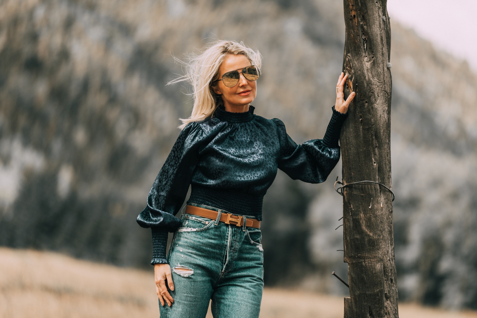 High Neckline Tops, fashion blogger Erin Busbee of BusbeeStyle.com wearing a high neck smocked leopard print blouse by Aqua from Bloomingdale's with agolde baggy jeans, hermes belt, and neutral booties in Telluride, CO