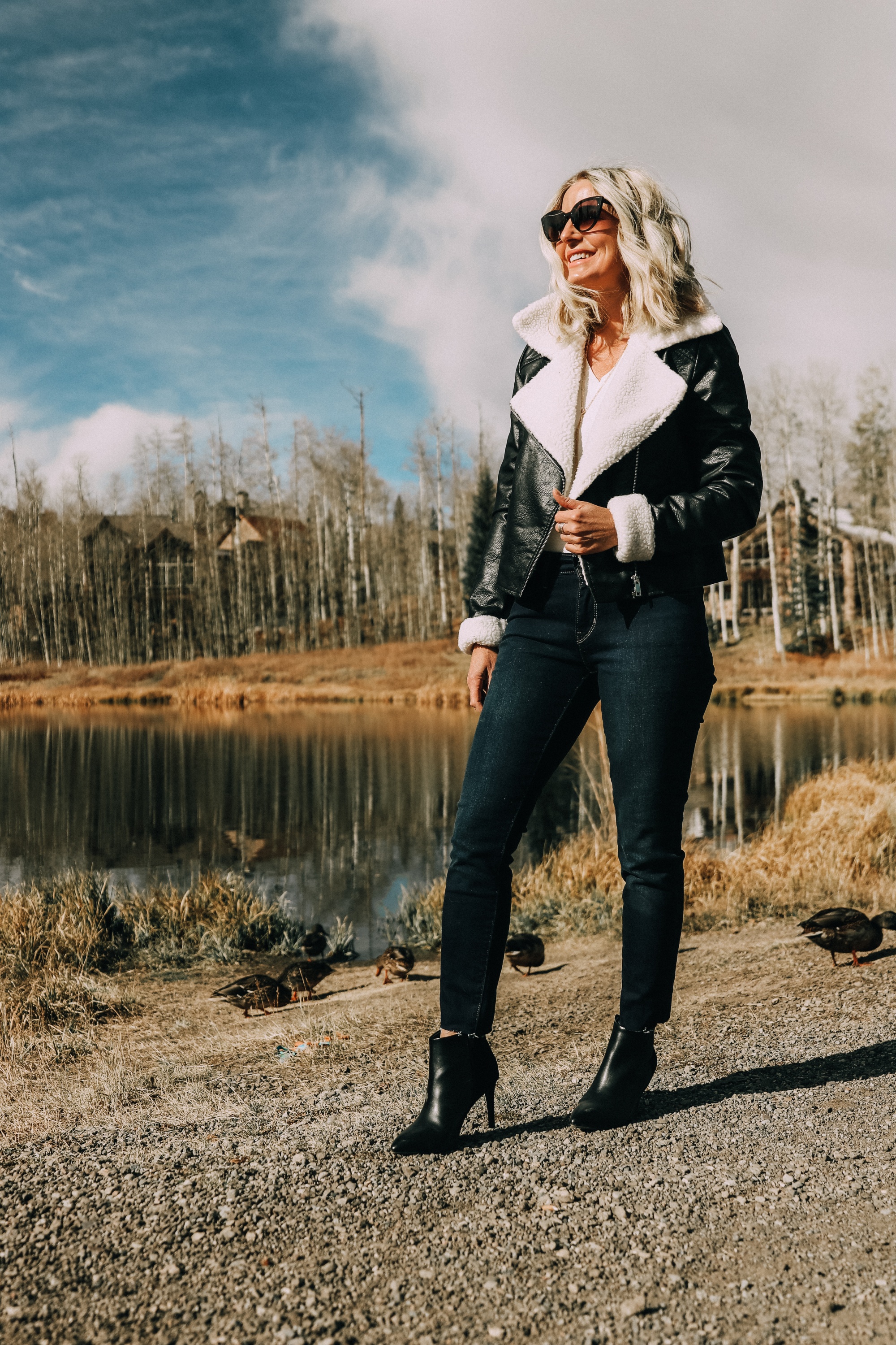 fashion blogger erin busbee wearing affordable black moto jacket with faux fur lining dark wash levis 711 skinny jeans black heeled booties from jcpenney