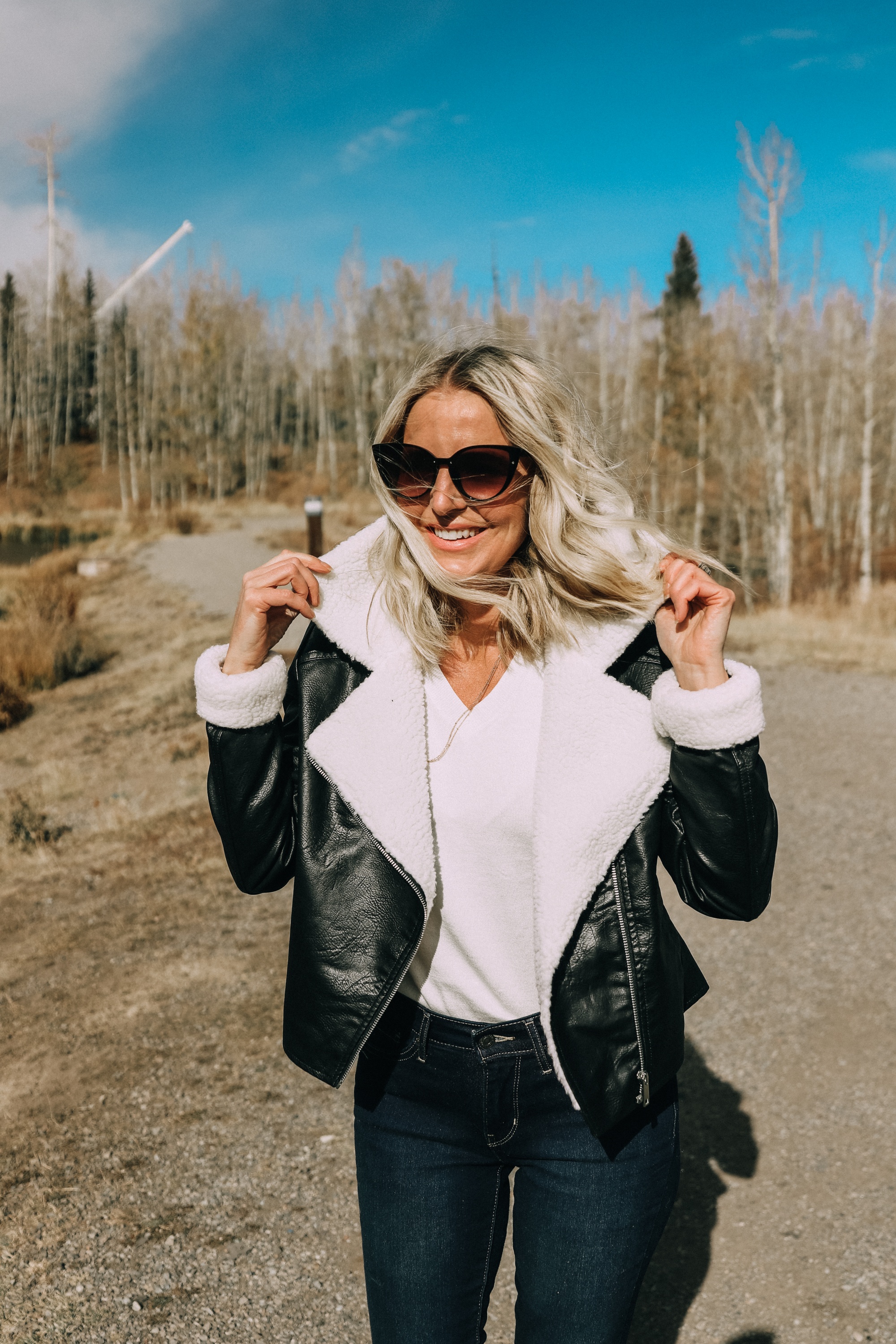 fashion blogger erin busbee wearing affordable black moto jacket with faux fur lining