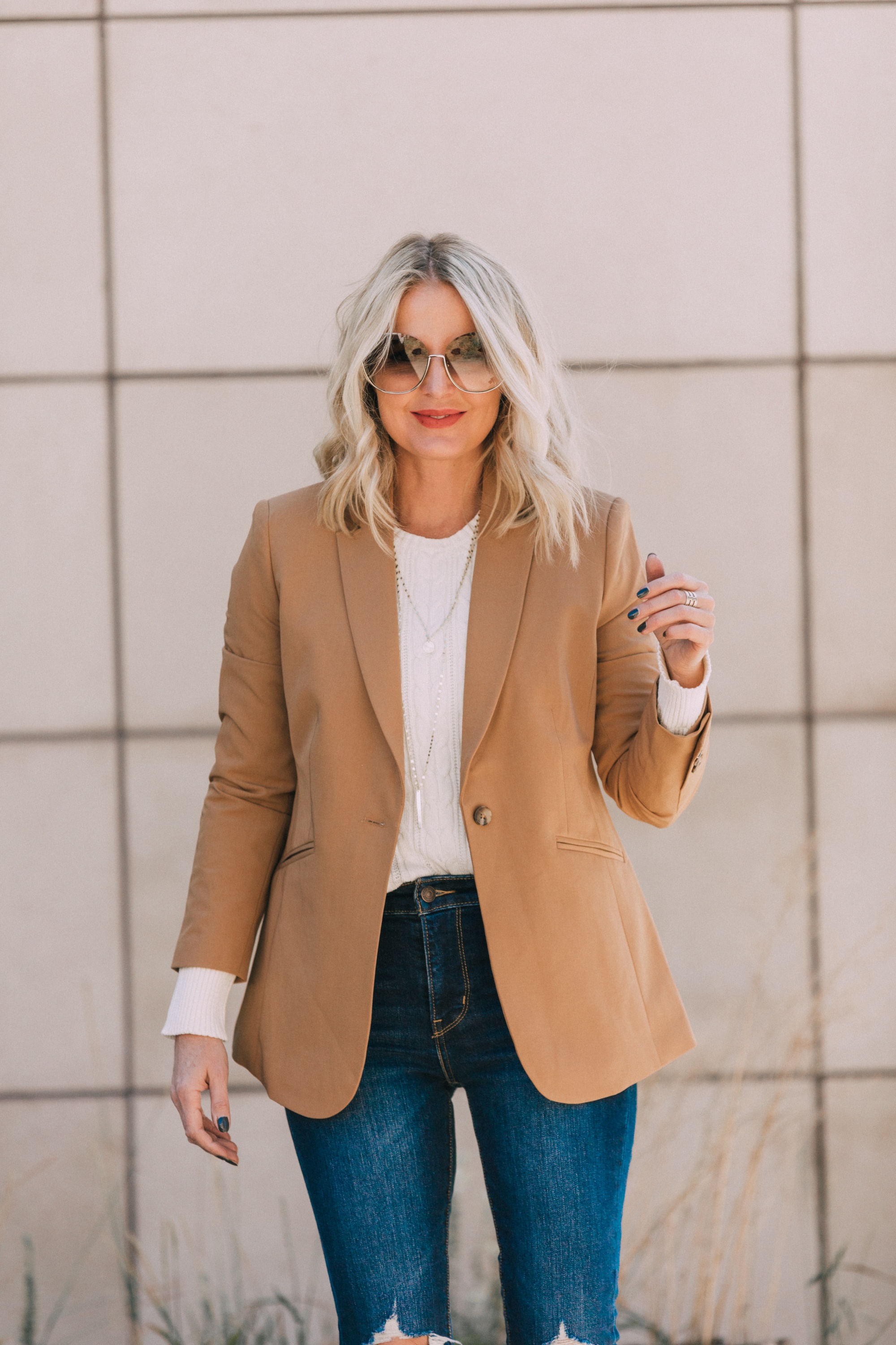 affordable camel colored blazer with blue jeans and white cable knit sweater outfit