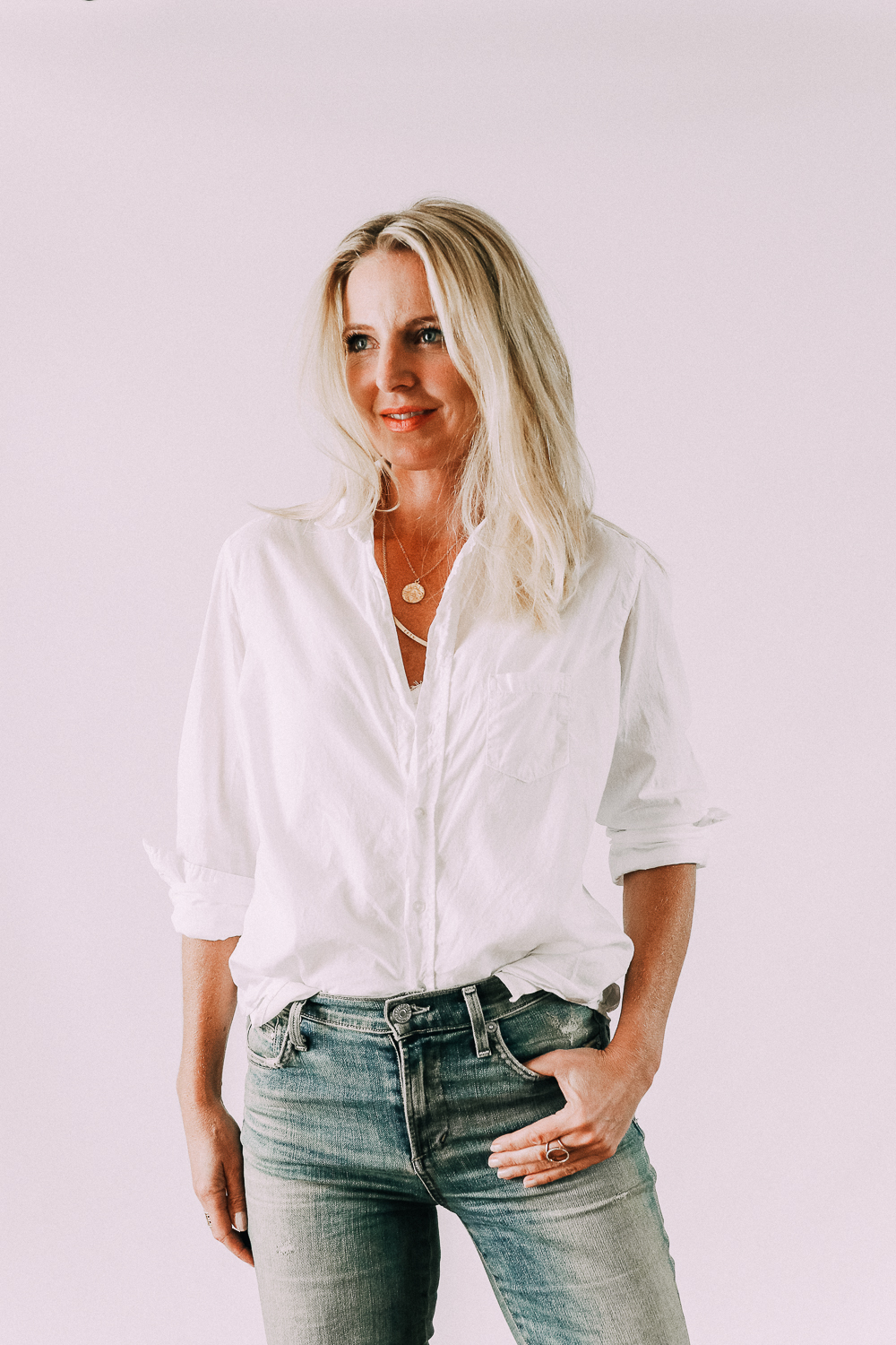 Women's fashion blogger, Erin Busbee, shares 5 fashion tips and cuffs the sleeves of her white button down shirt