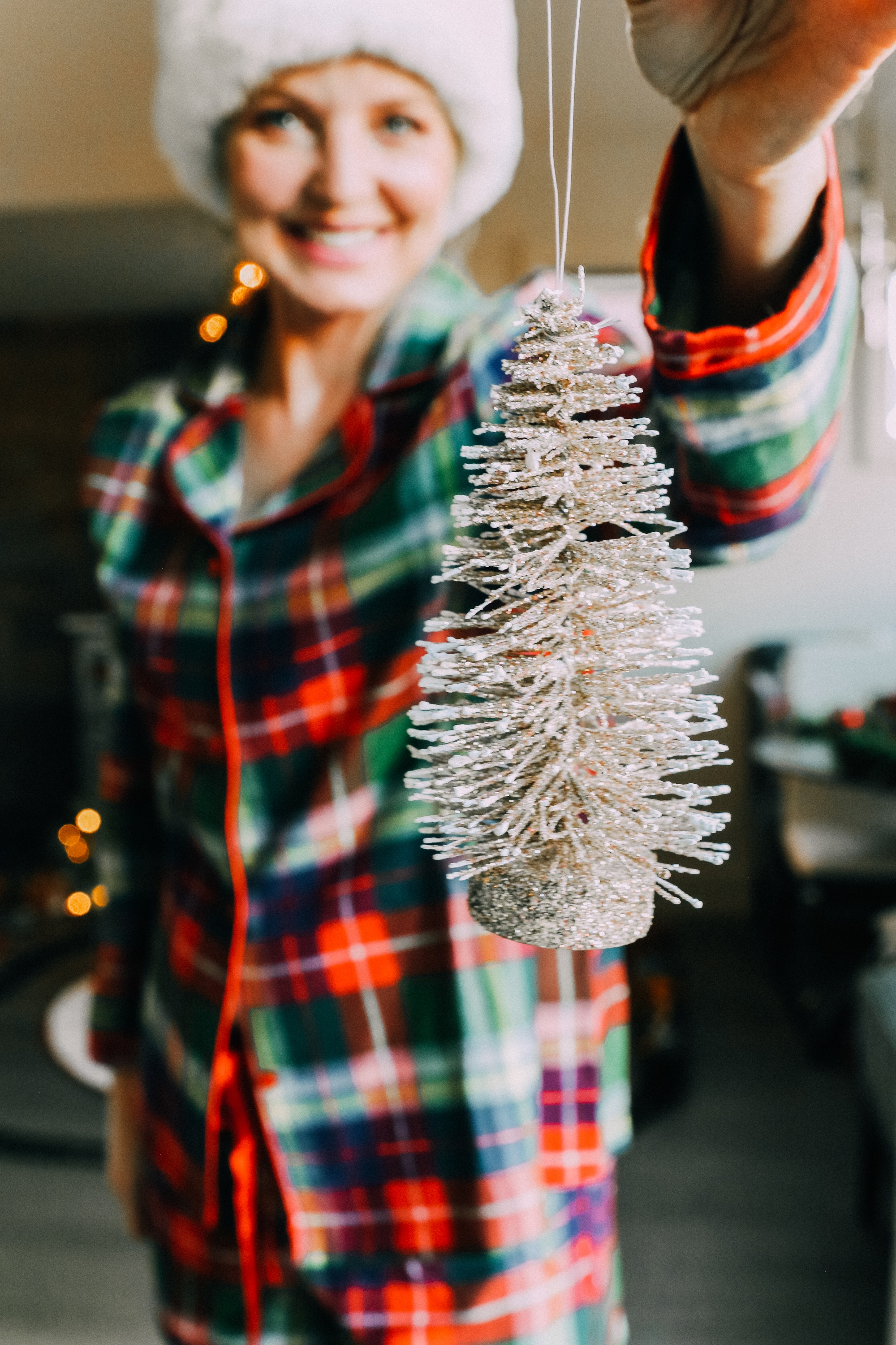 How to make holiday decorating easier, Fashion blogger Erin Busbee of BusbeeStyle.com sharing how to make the holidays more stress free wearing plaid pajamas shorts and top by Jockey and a Santa hat by her pre-lit tree in Telluride, CO