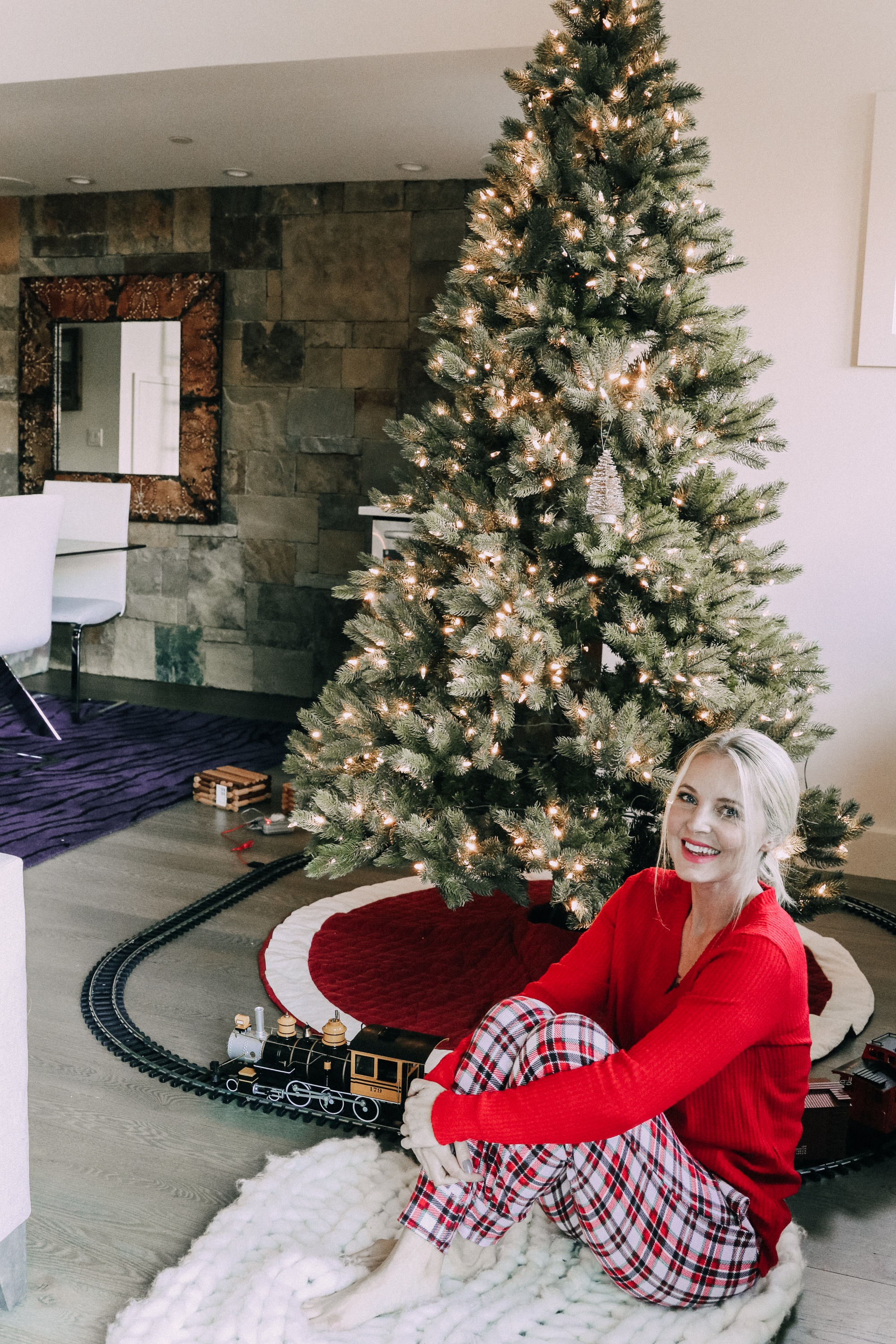 How to make holiday decorating easier, Fashion blogger Erin Busbee of BusbeeStyle.com sharing how to make the holidays more stress free wearing plaid pajamas and a red top by Jockey by her pre-lit tree in Telluride, CO