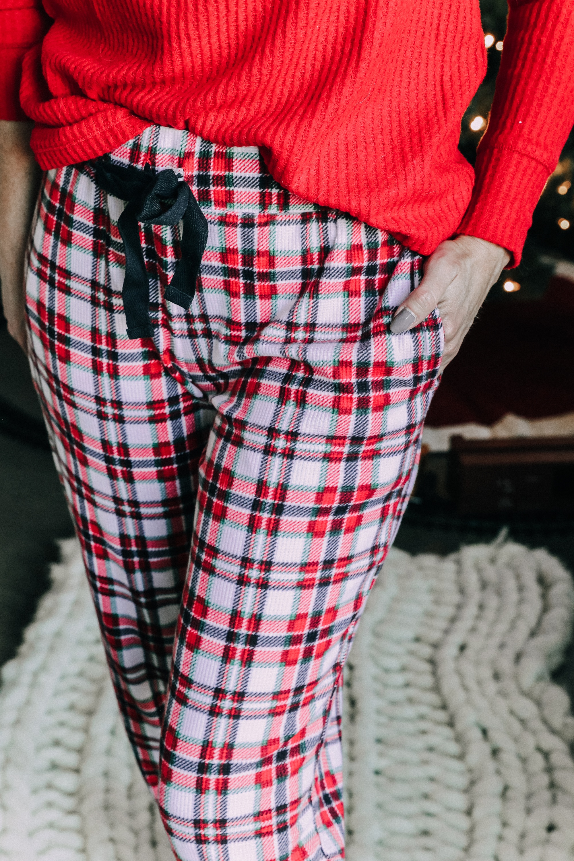 How to make holiday decorating easier, Fashion blogger Erin Busbee of BusbeeStyle.com sharing how to make the holidays more stress free wearing plaid pajamas and a red top by Jockey by her pre-lit tree in Telluride, CO