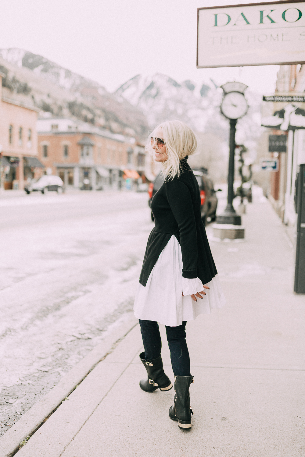 Vince Camuto Sale, Fashion blogger Erin busbee of BusbeeStyle.com carrying the robin tote from Vince Camuto wearing black moto boots and a endless rose sweater dress with dark wash skinny jeans in telluride colorado
