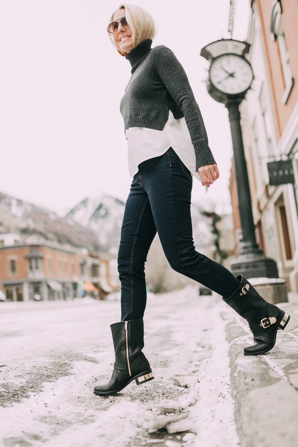 Vince Camuto Sale, Fashion blogger Erin Busbee of BusbeeStyle.com wearing the Vince Camuto Winchell moto boots with dark wash skinny jeans and a layered sweater in Telluride, CO