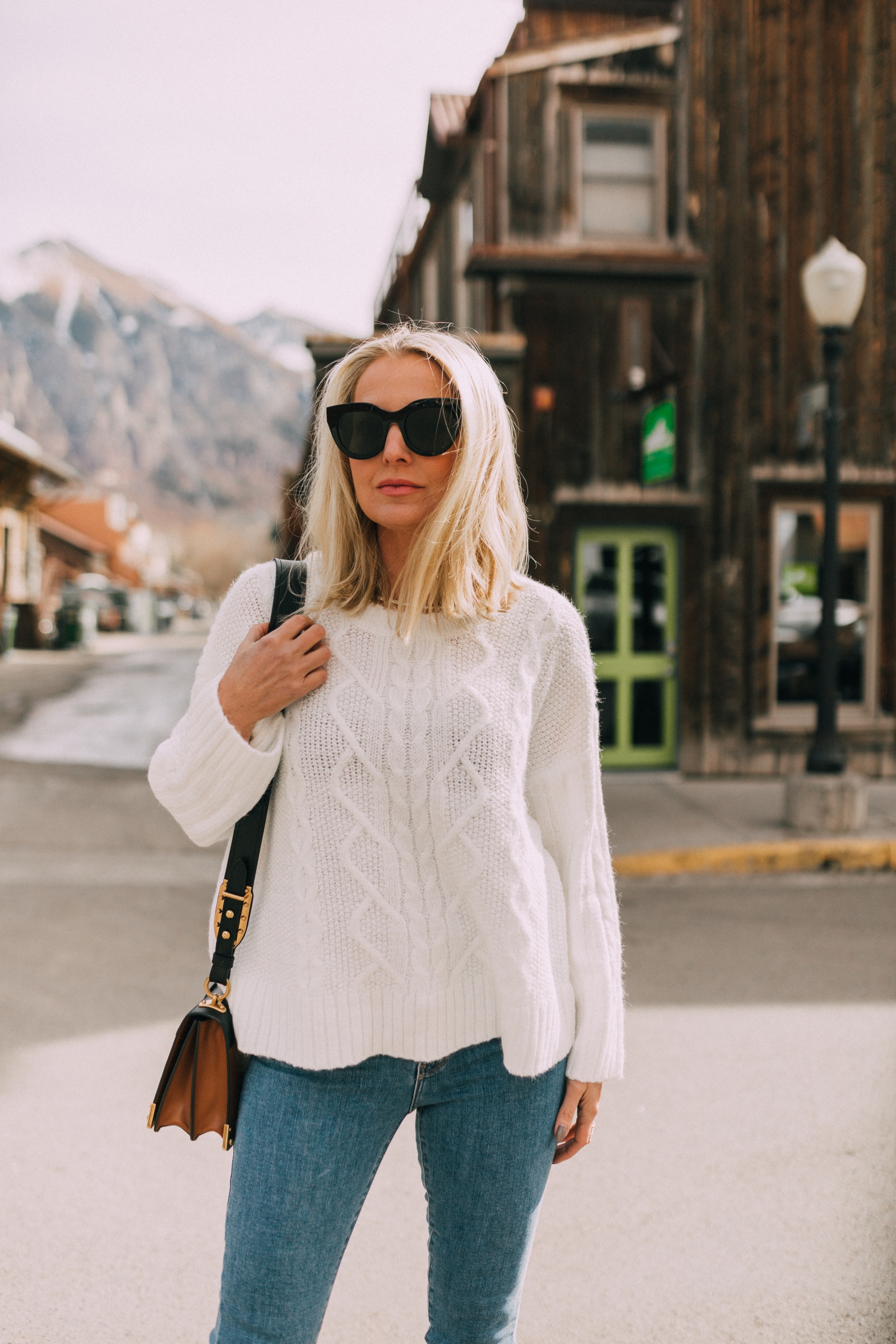 fashion blogger wearing cheap affordable cute fall sweater outfit blue jeans white crewneck sweater telluride colorado