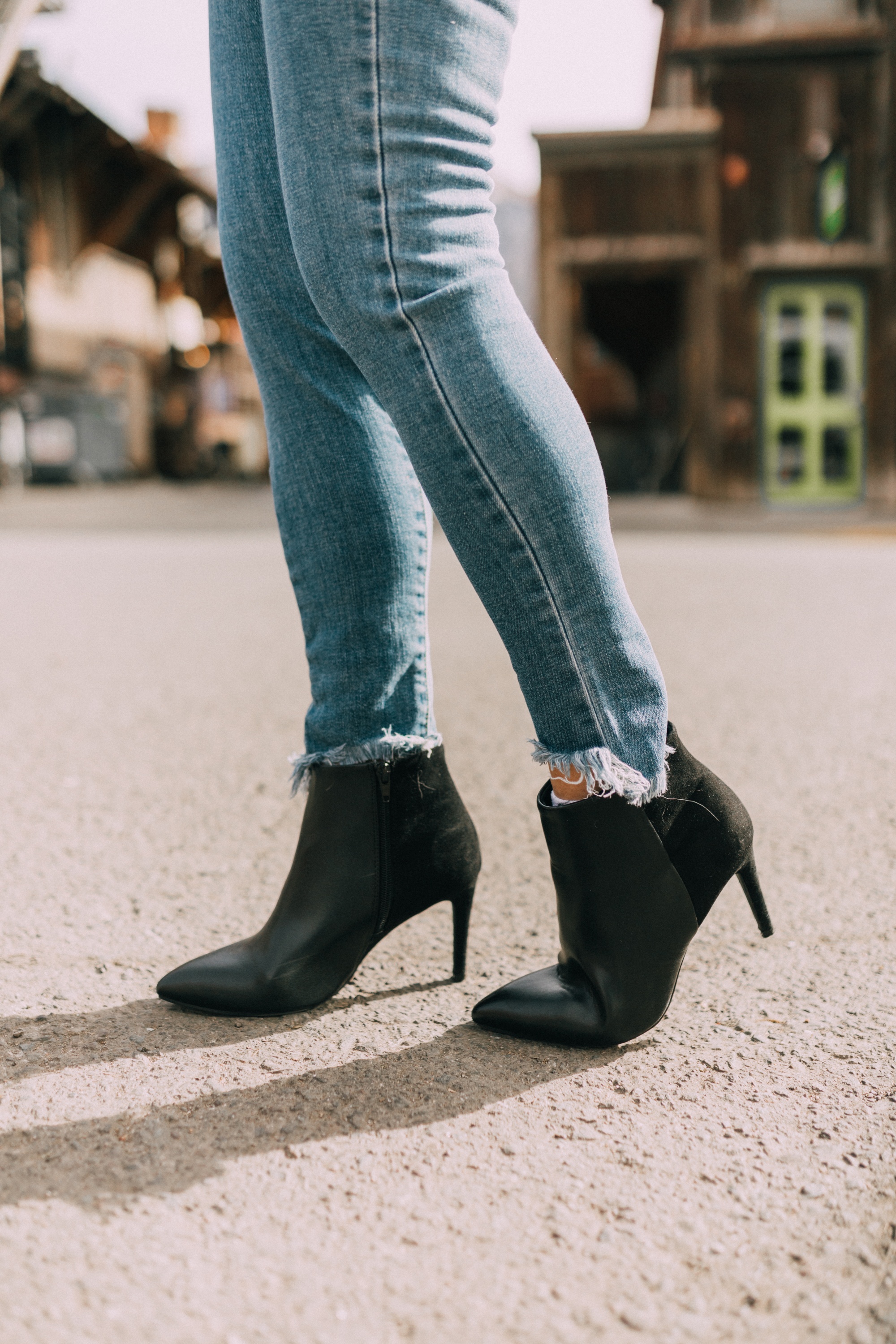 ripped hem blue jeans outfit with black booties in telluride