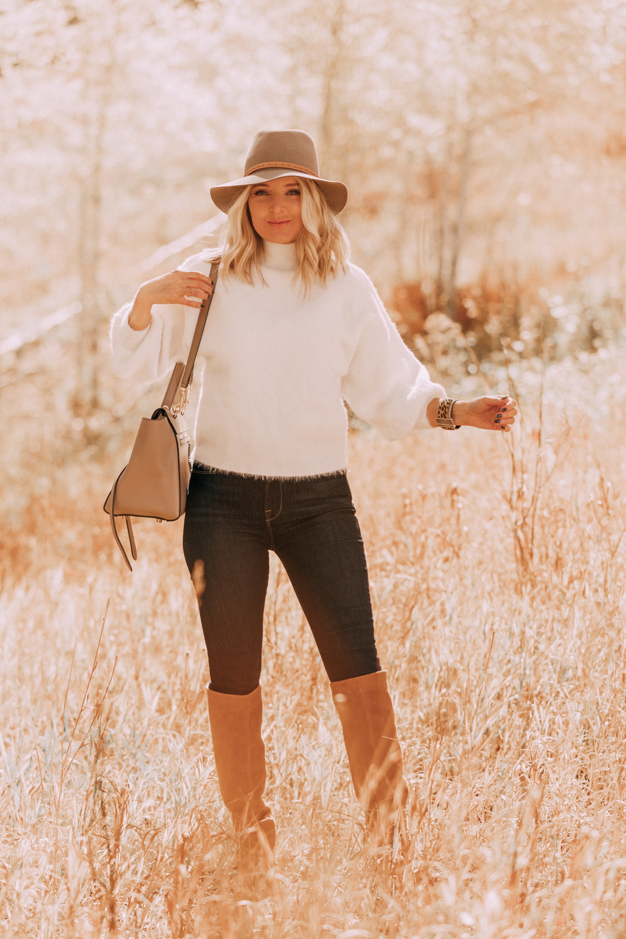 Rag & Bone fedora hat paired with white fuzzy sweater and dark wash jeans on fashion blogger over 40 Erin Busbee of Busbee Style