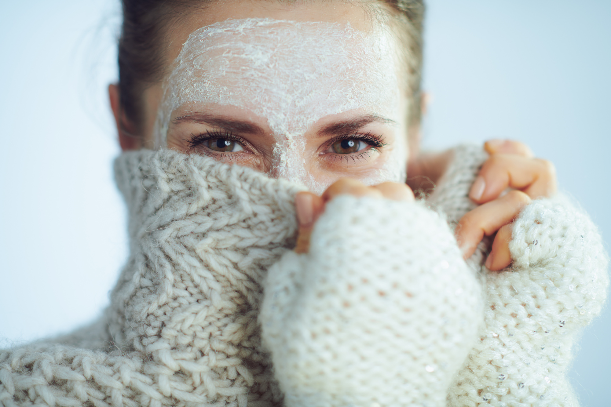 woman winter sweater, skincare travel tips, beauty routine while traveling, travel skincare routine