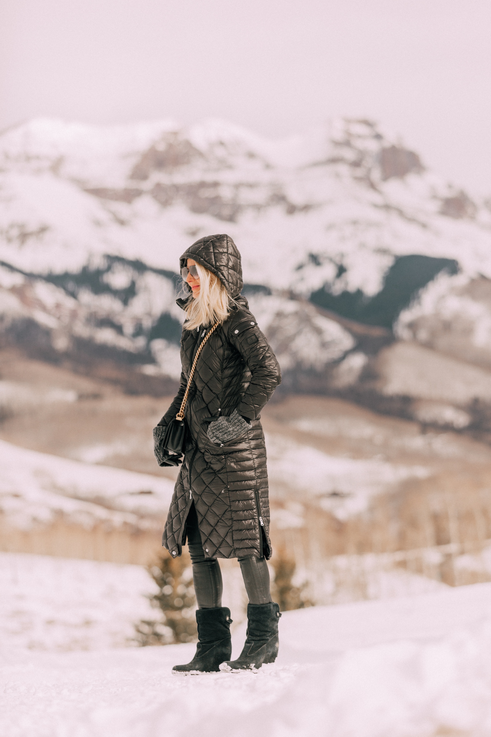 puffer coat outfit Fashion blogger wearing Herno puffer coat over black turtleneck sweater with Citizens of Humanity Rocket leatherette skinny jeans, Ugg wedge boots in Telluride, CO
