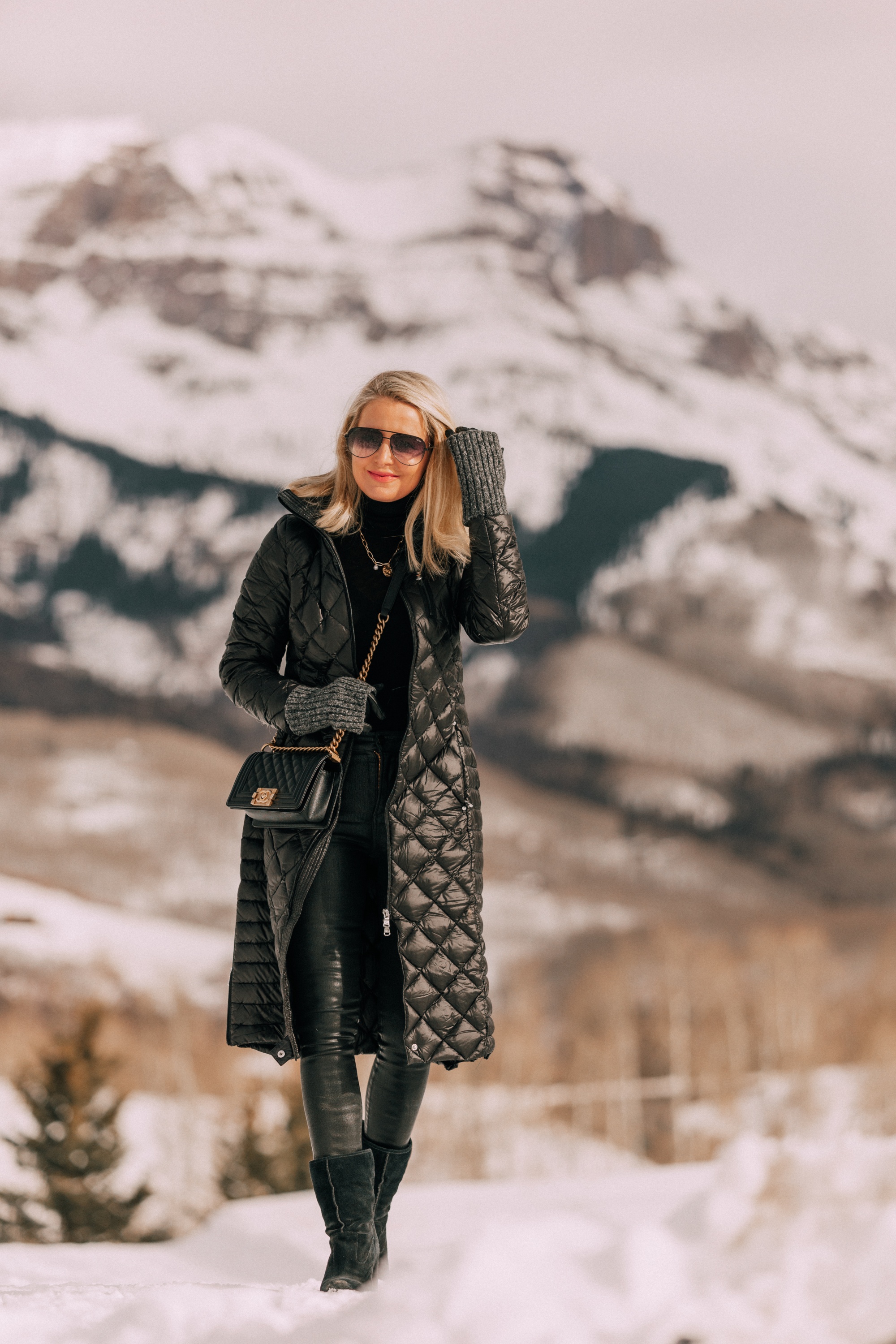 puffer coat outfit Fashion blogger wearing Herno puffer coat over black turtleneck sweater with Citizens of Humanity Rocket leatherette skinny jeans, Ugg wedge boots in Telluride, CO