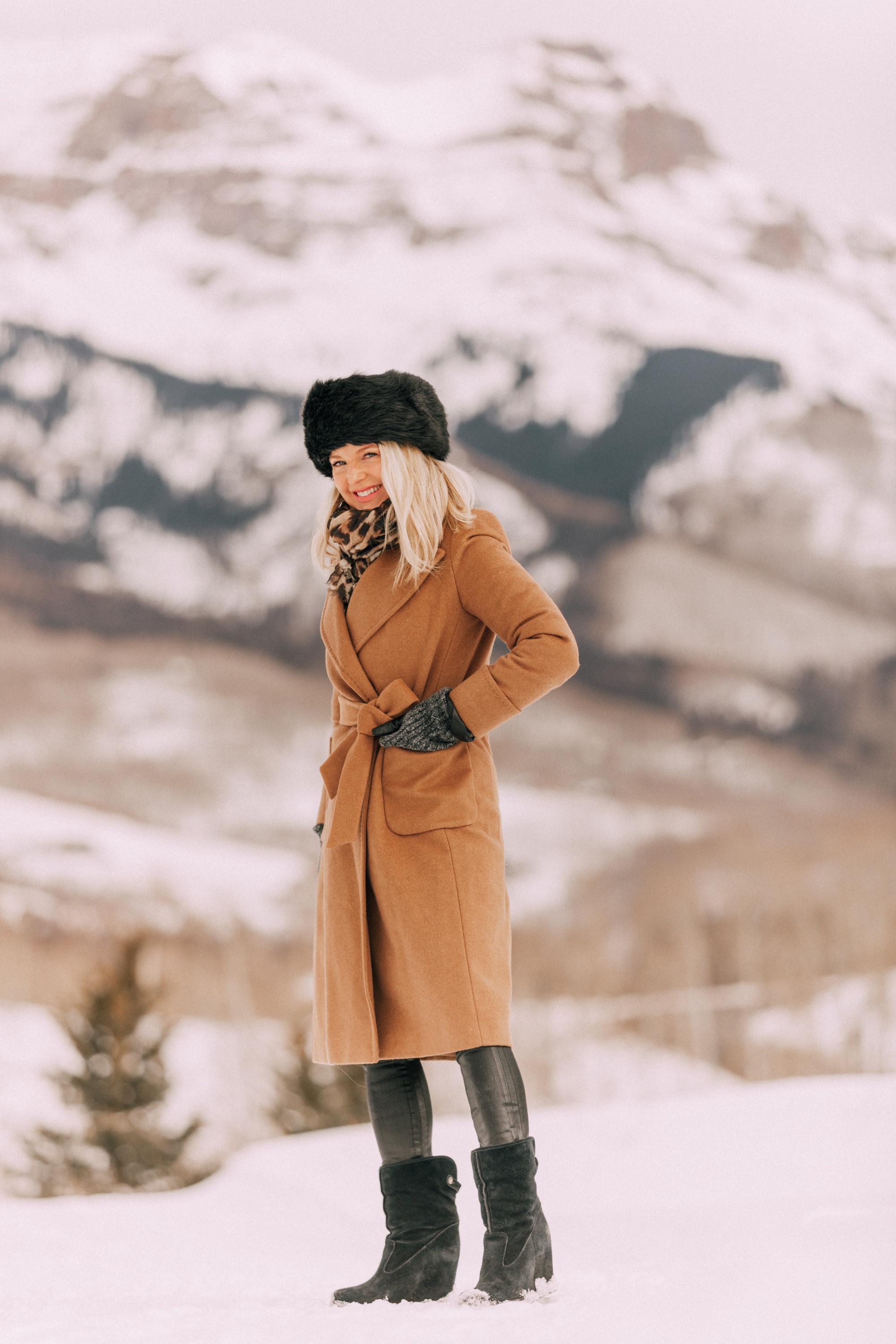 how to layer winter clothes to stay warm and look stylish, cold weather outfit black turtleneck sweater Citizens of Humanity Rocket leatherette skinny jeans, Ugg wedge boots, camel wool Mackage coat Mackage, and Herno puffer coat in Telluride, CO