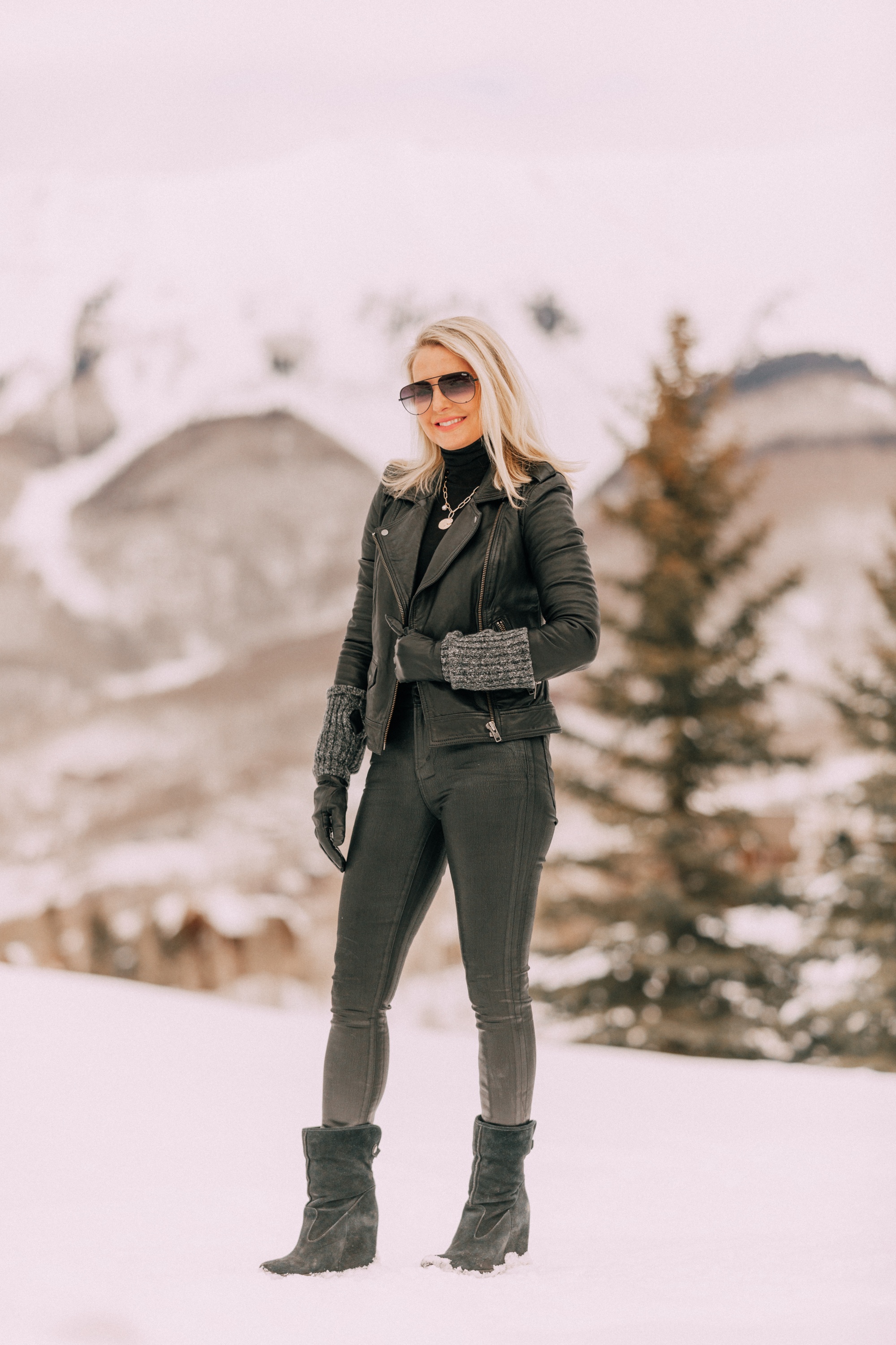 layered Moto Jacket outfit on Fashion blogger wearing a black leather IRO moto jacket, Carolina Amato gloves, rocket leatherette skinny jeans by Citizens of Humanity, black cashmere turtleneck, and Ugg wedge boots in Telluride, CO