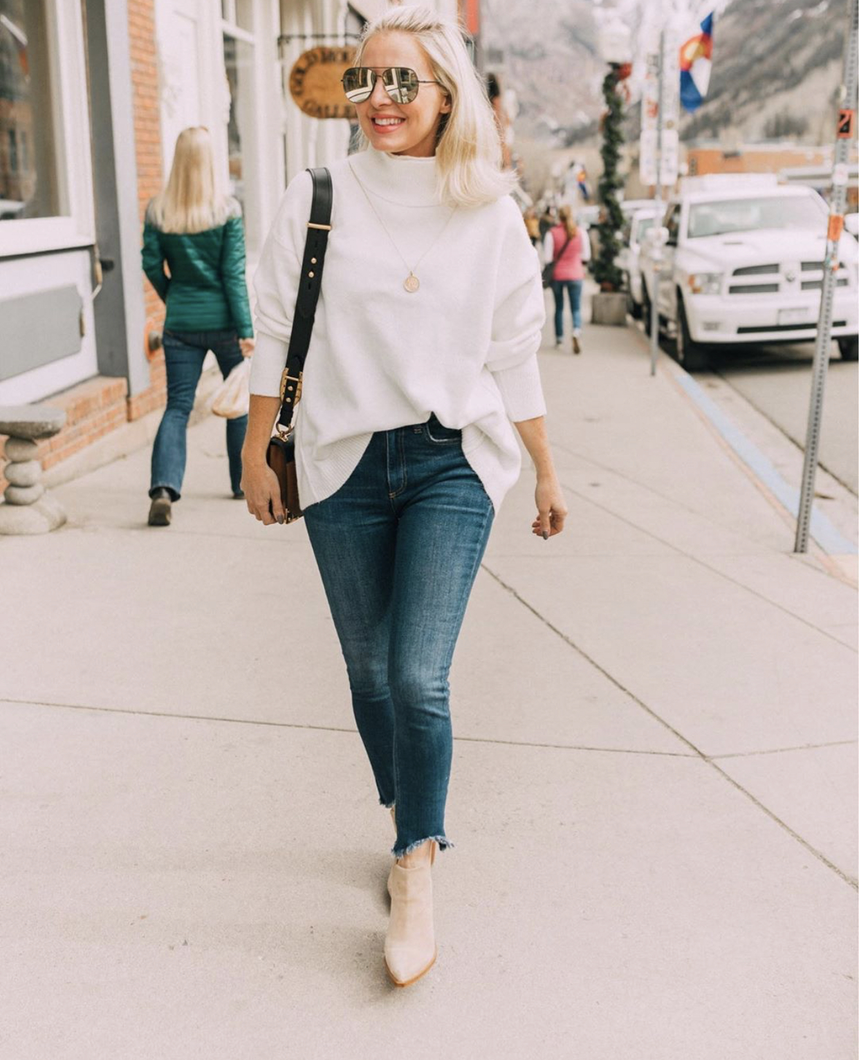 Monthly Favorites, Fashion blogger Erin Busbee of BusbeeStyle.com wearing a white turtleneck sweater with skinny jeans and Vince Camuto booties in Telluride, Colorado