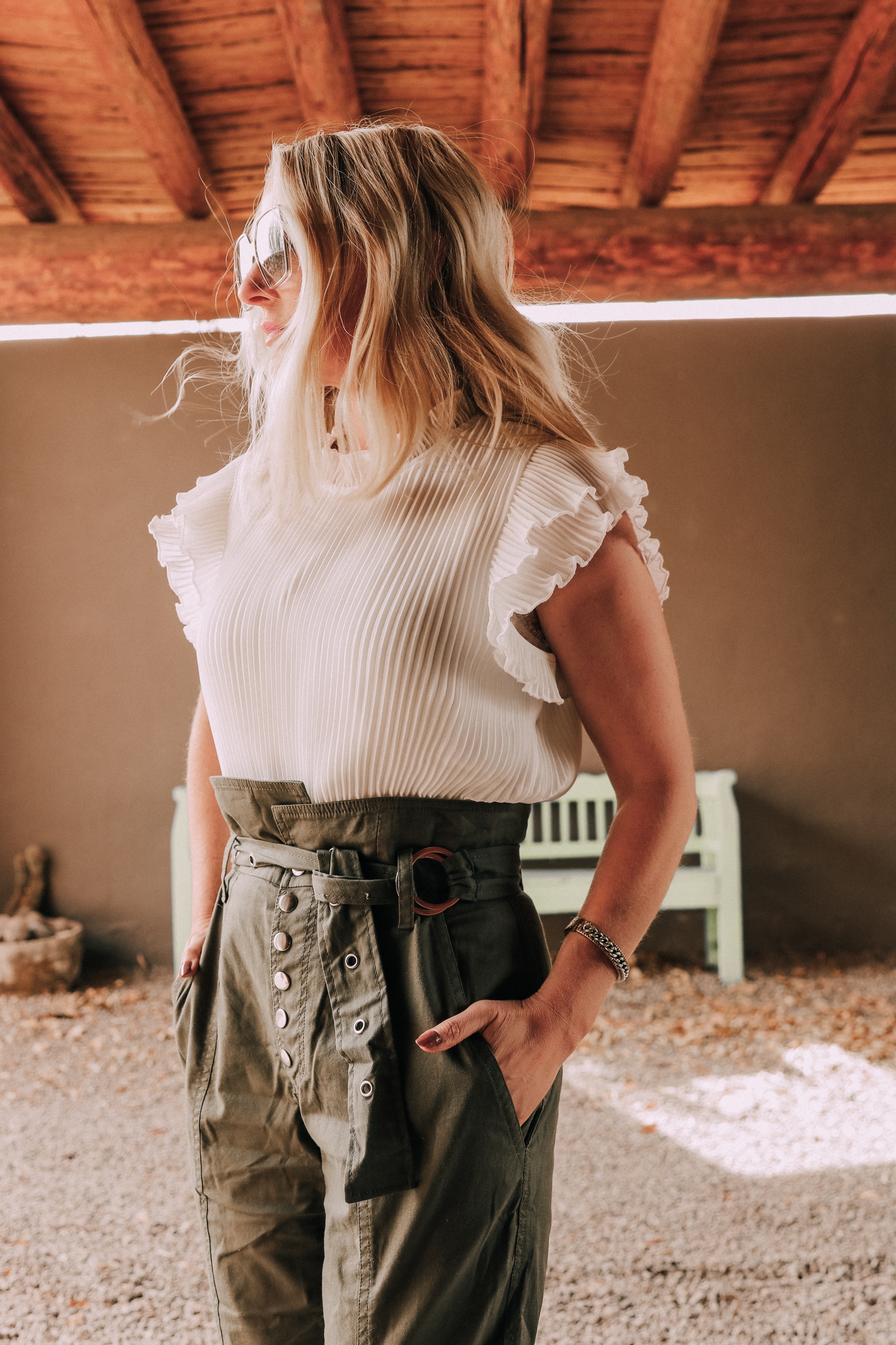 Edgy Classic Style, Fashion Blogger Erin Busbee of BusbeeStyle.com wearing green Gia Pants by Marissa Webb with a white ruffle blouse by Gibson from Nordstrom with camo Linea Paolo wedge sneakers at Cibolo Creek Ranch in Texas