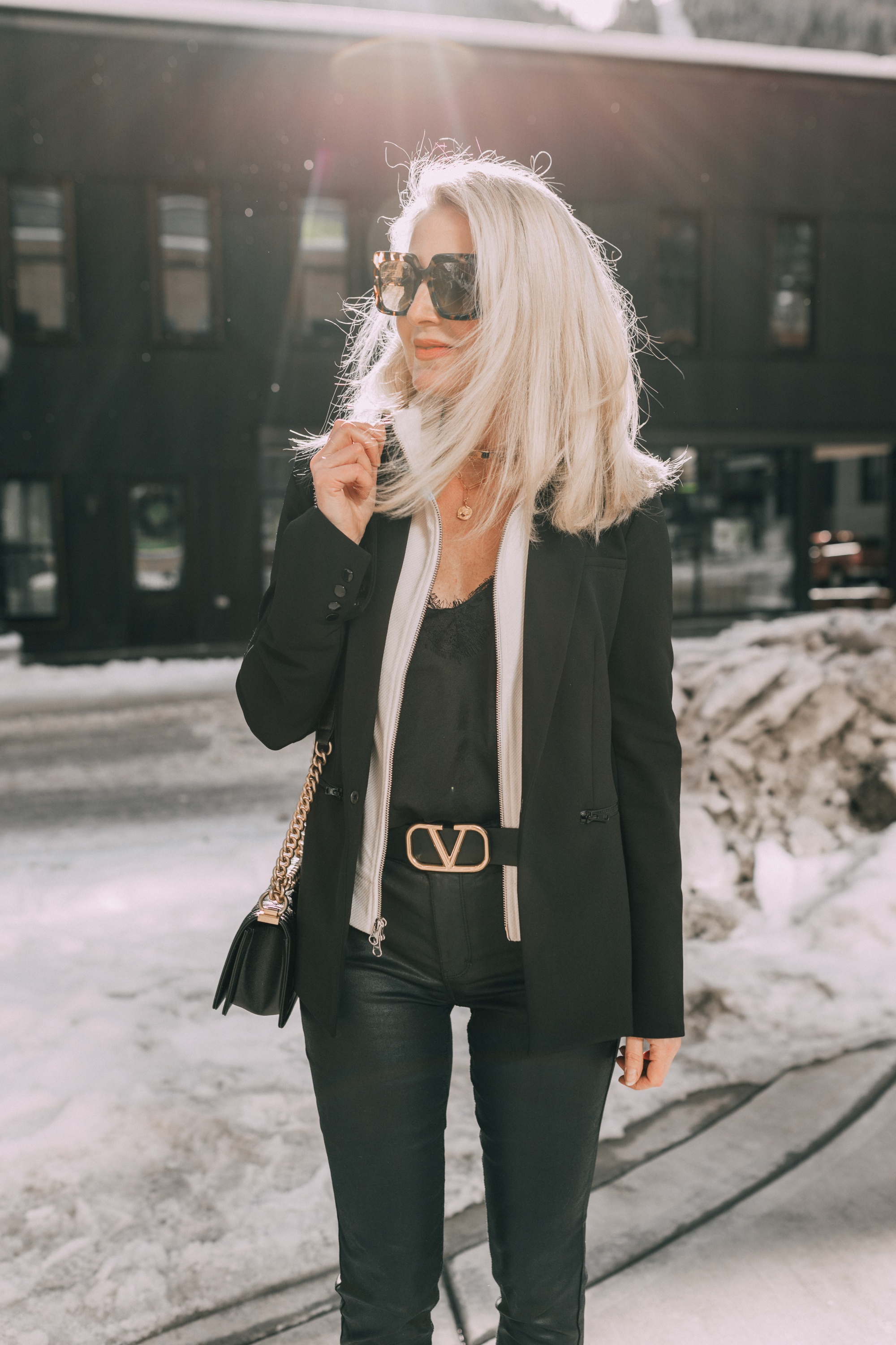 black Veronica Beard blazer date night outfit with ivory blazer dickey, black lace cami, gold valentino belt black jeans look for women over 40, Veronica