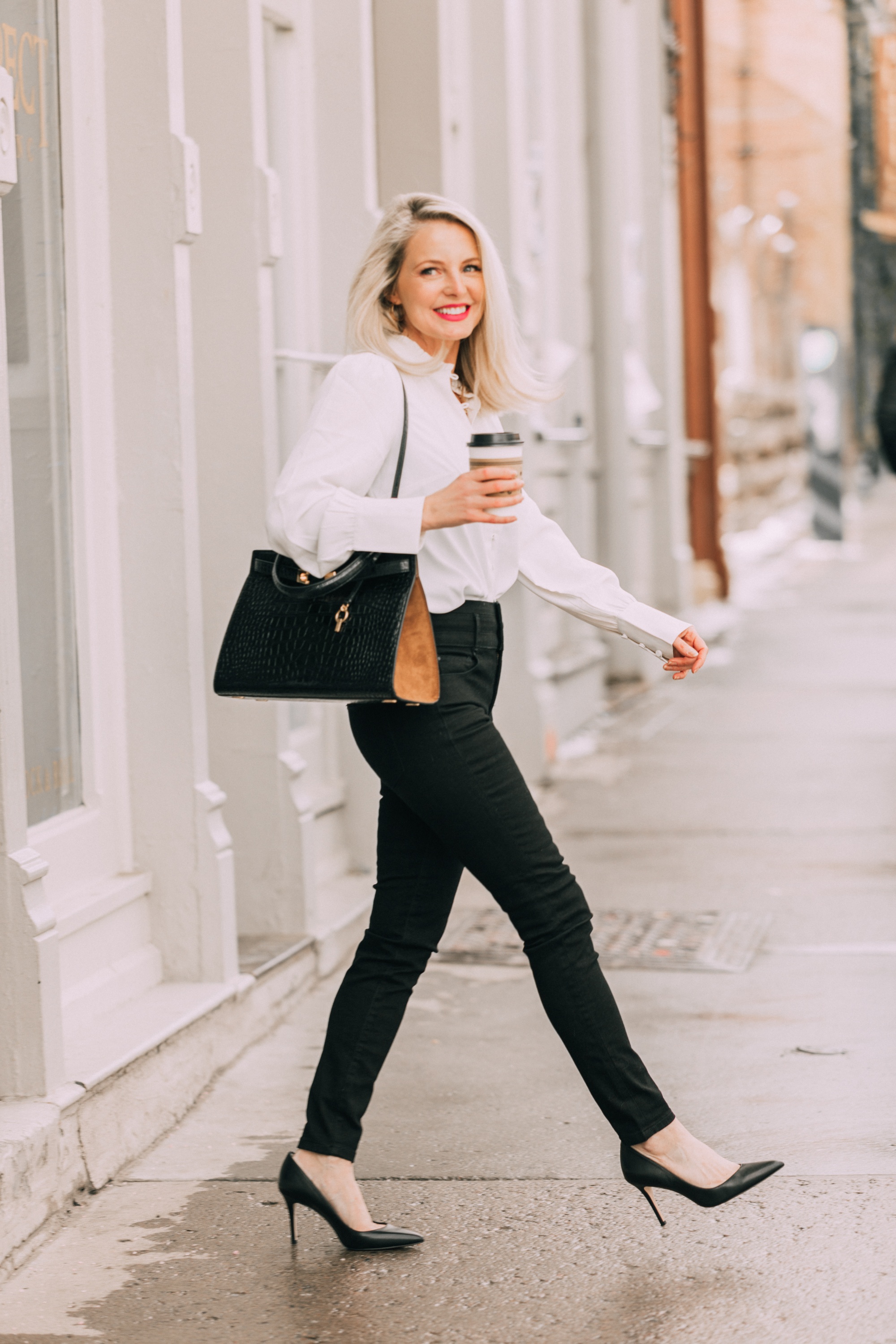 Wardrobe Basics, Fashion blogger Erin Busbee of BusbeeStyle.com wearing black pocket sculpting jeans, a white ruffle neck blouse, black pumps, bar link necklace, and cutout hoops earrings all from Ann Taylor in Telluride, Colorado
