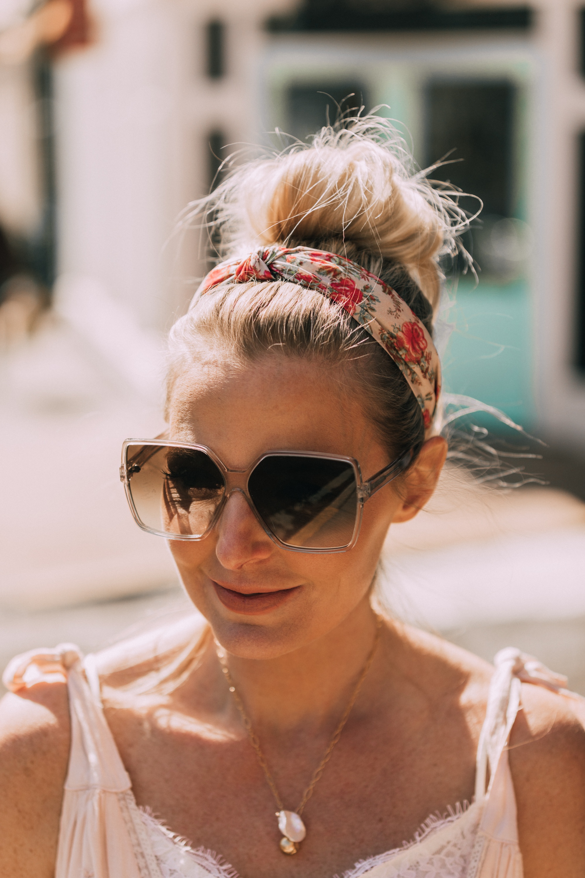 How To Wear A Maxi Dress, Fashion blogger Erin Busbee of BusbeeStyle.com wearing a peach Free People Lily of the Valley Maxi dress with brown block heel sandals, white lace cami underneath, floral headband, gold necklace, and sunglasses walking in Telluride, Colorado