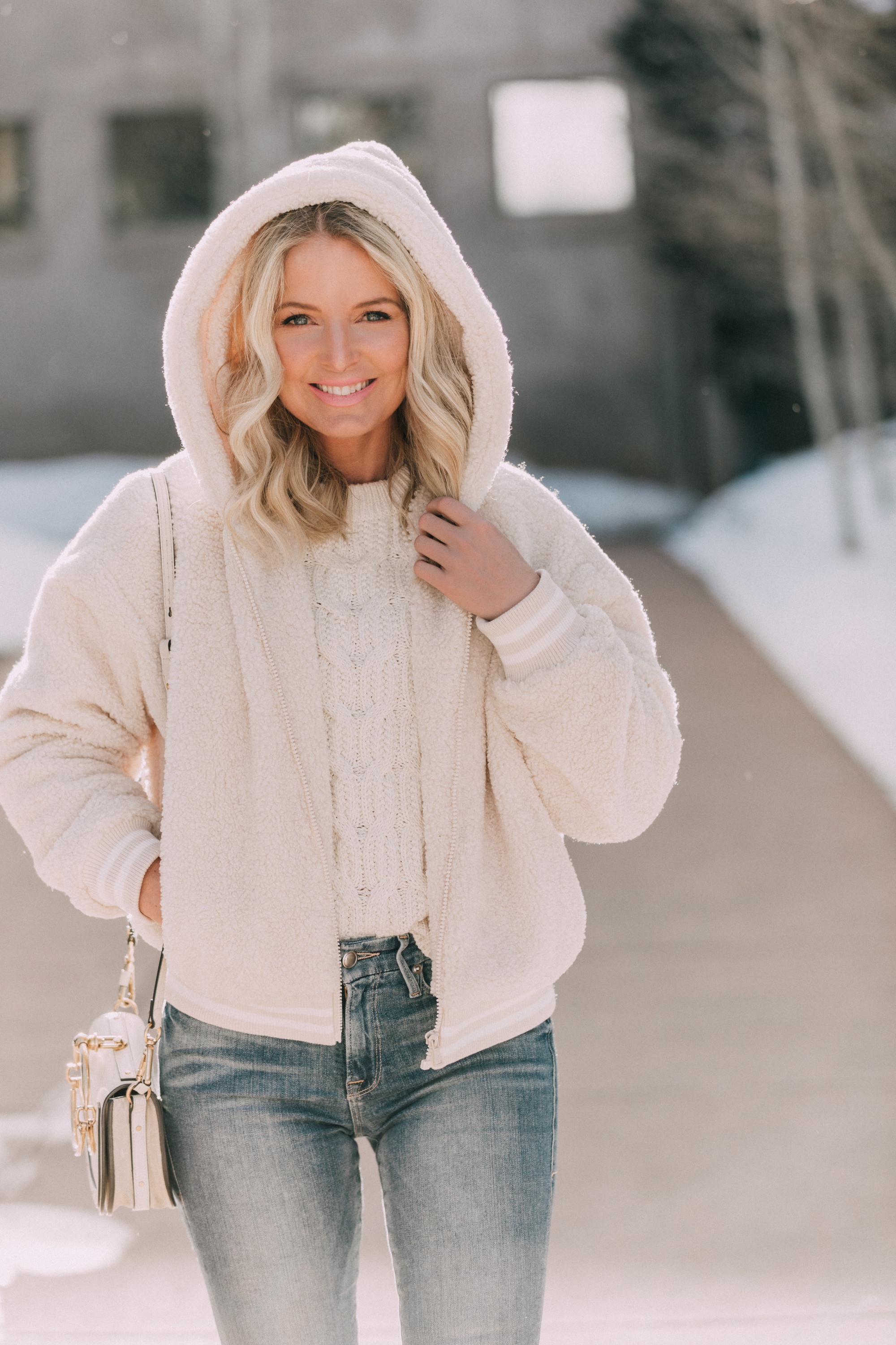 walmart fashion blogger wearing cozy faux fur teddy Scoop jacket, white Scoop cable knit sweater, medium wash skinny jeans