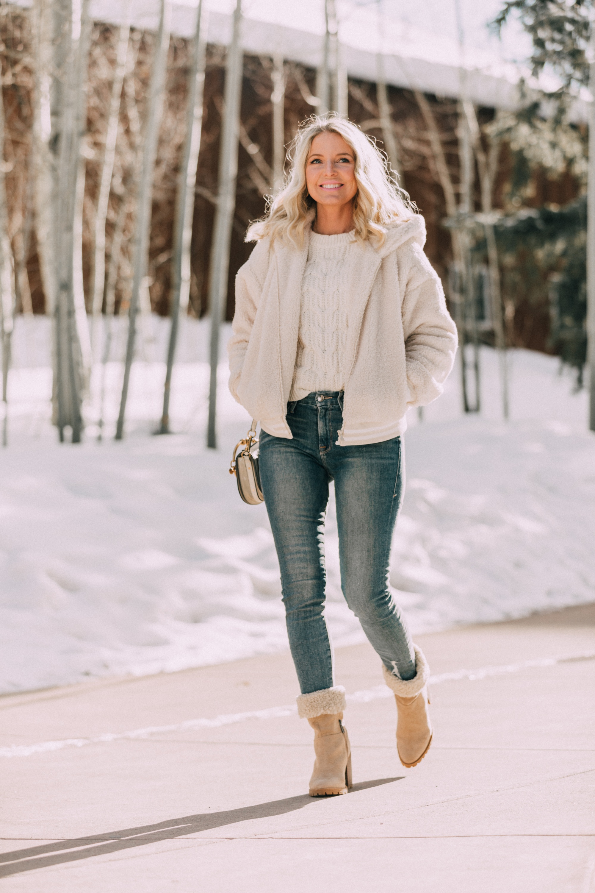 Winter White, Fashion blogger Erin Busbee of BusbeeStyle.com wearing a faux fur teddy jacket by Scoop, white cable knit sweater by Scoop, medium wash skinny jeans, and faux shearling foldover boots by Scoop from Walmart in Telluride, Colorado