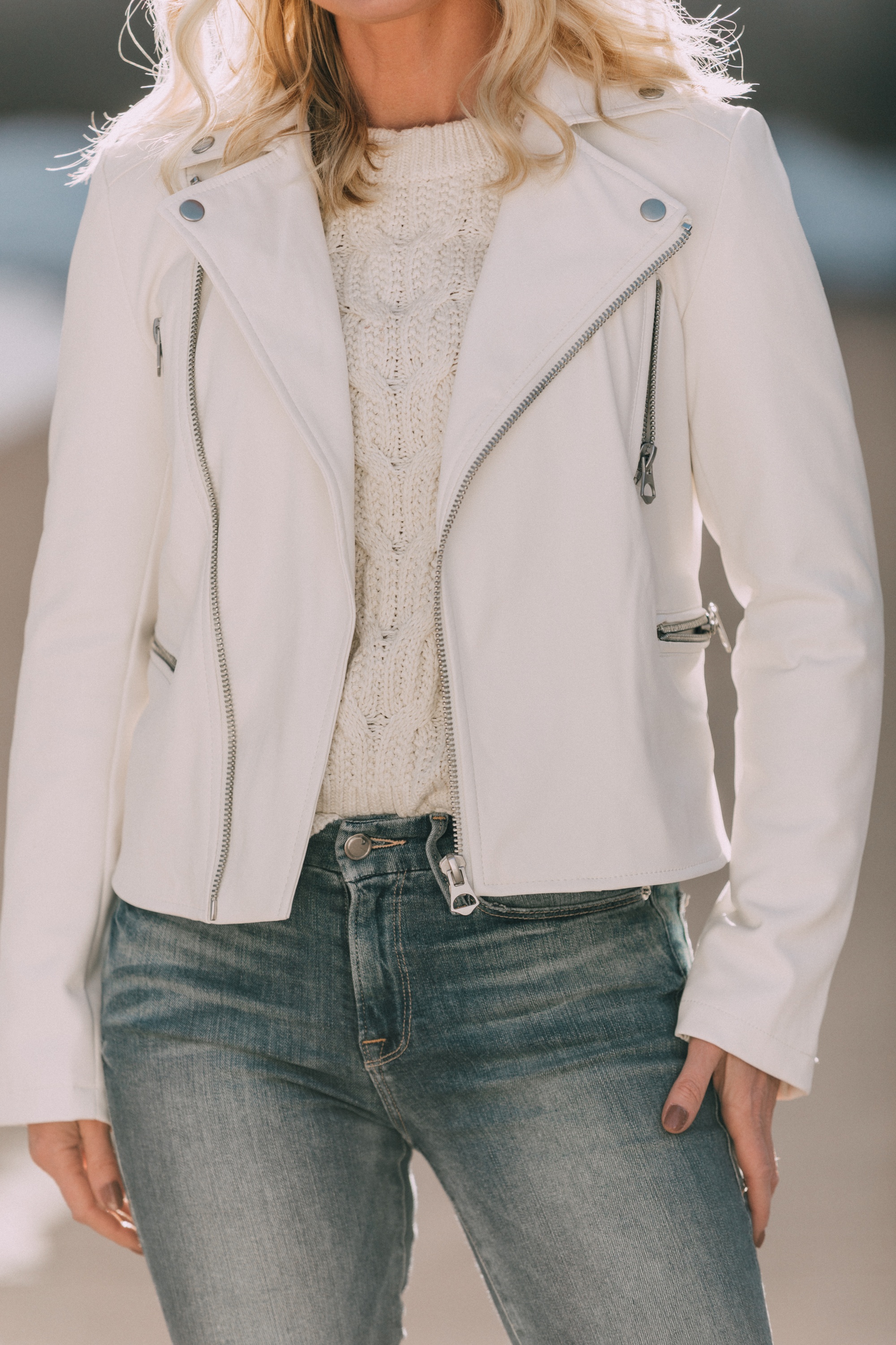 walmart scoop fashion blogger wearing white faux leather moto jacket, white cable knit sweater and medium wash skinny jeans in Telluride, Colorado