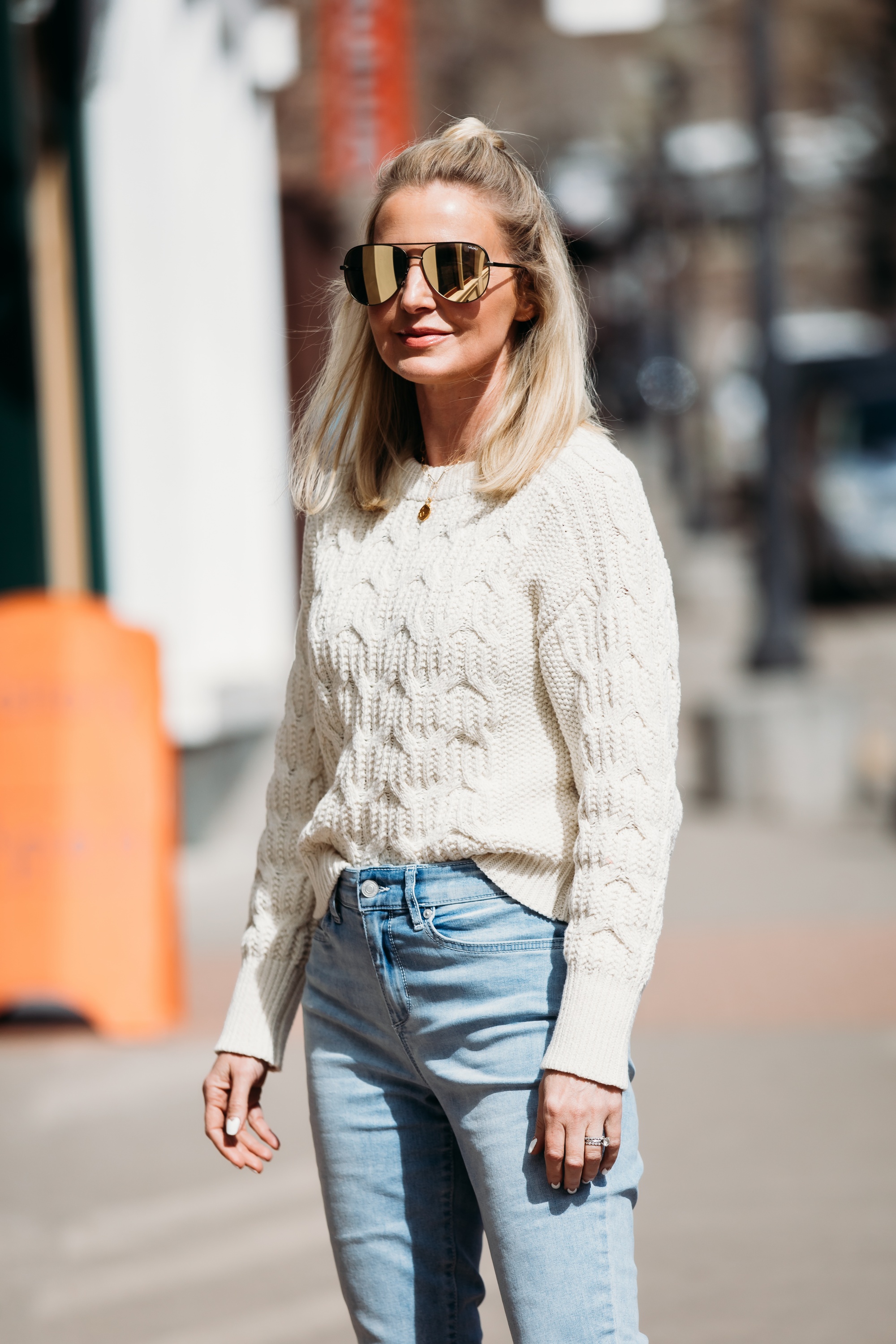 White Sweaters, Fashion blogger Erin Busbee of BusbeeStyle.com wearing a white cable knit sweater by Scoop, light wash skinny jeans by Sofia Vergara, brown suede booties, and green mirrored QUAY sunglasses from Walmart in Telluride, Colorado