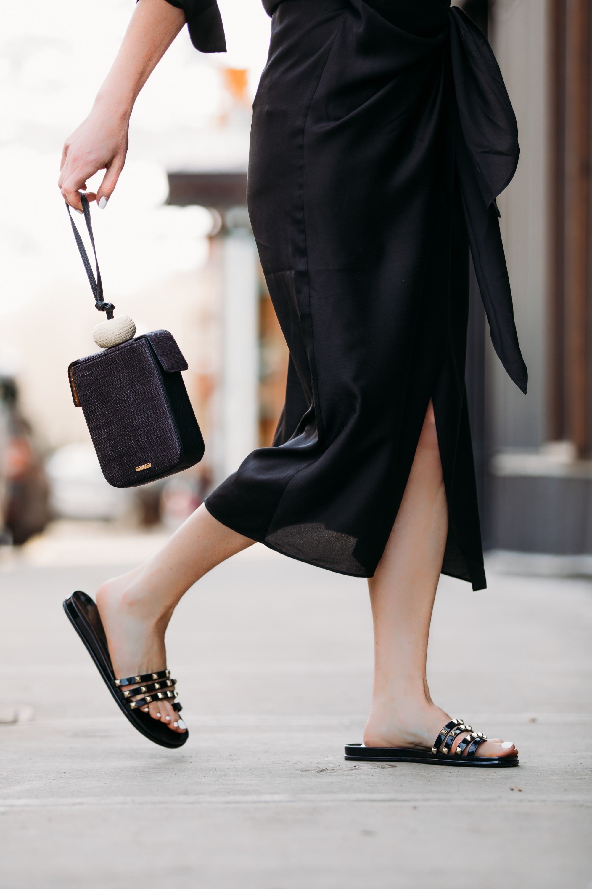 Spring Accessories, Fashion blogger Erin Busbee of BusbeeStyle.com wearing a black L'Academie shirt dress with black studded strappy slides and black bracelet bag from Vince Camuto in Telluride, Colorado