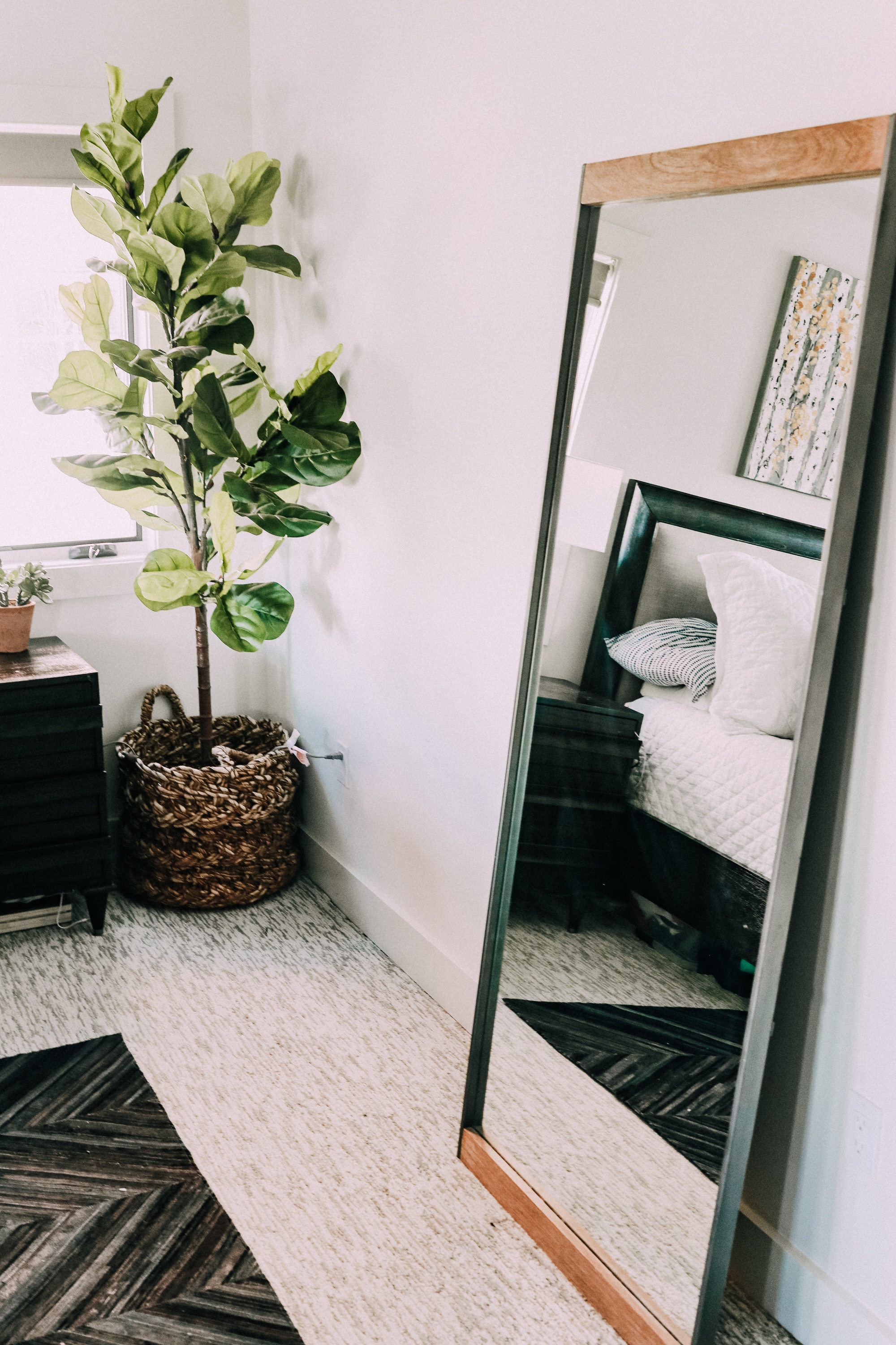 full length floor mirror against wall master bedroom decor in telluride, colorado, faux fiddle leaf fig in basket