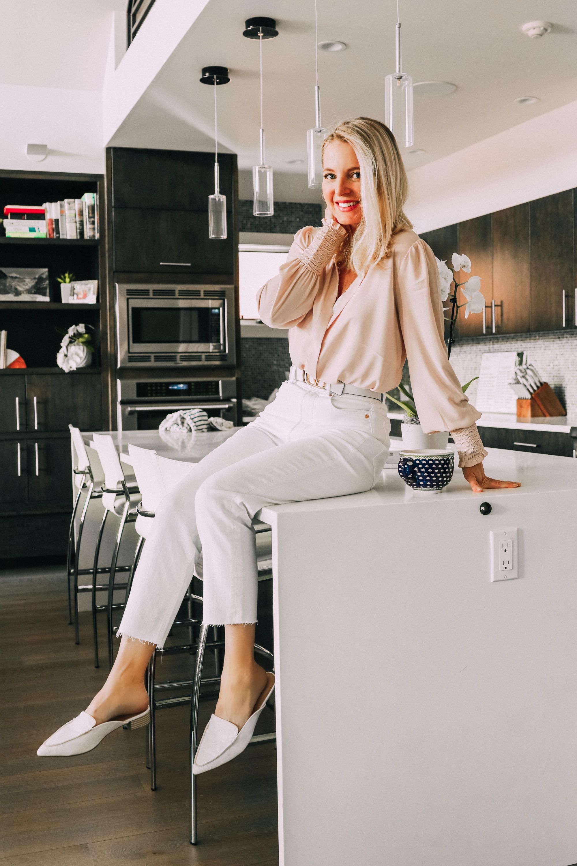 Work from home outfits from Express featuring multi-strand layered necklace, pale pink button-down blouse, white cropped mom jeans, valentino belt and white mock croc slide loafers