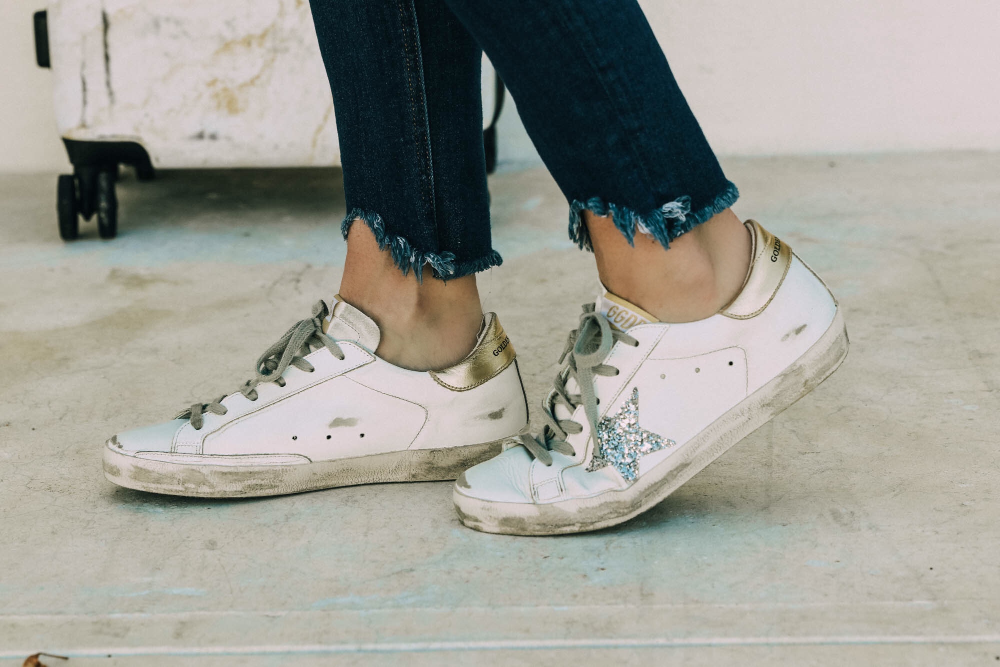 Golden Goose Sneakers Review, Fashion blogger Erin Busbee of Bubsee Style wearing Golden Goose superstar sneakers with frayed jeans in the Bahamas