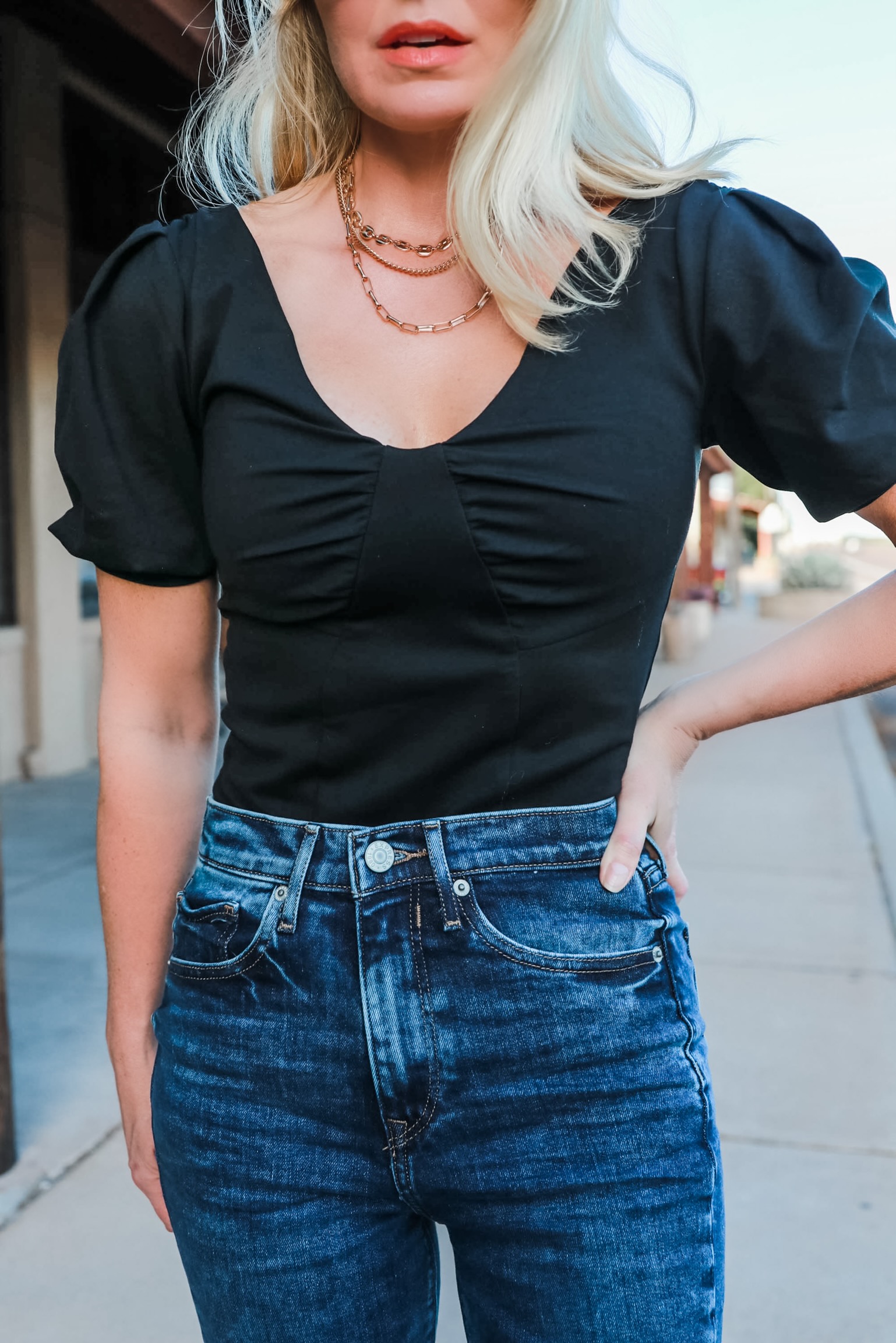 Express super high waisted dark wash Mom Jeans outfit over black off the shoulder thong bodysuit shiny gold layered three chain necklace