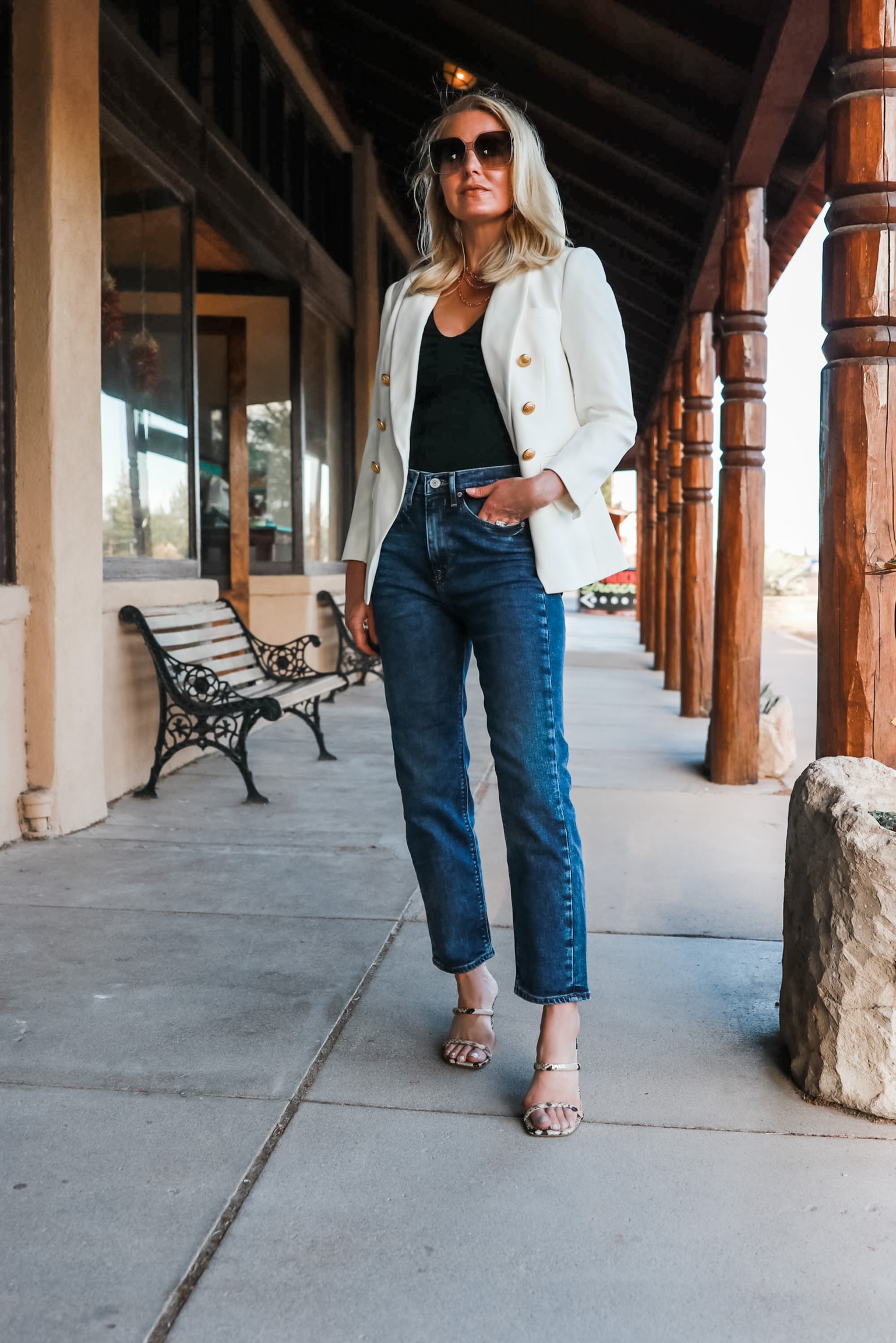 fashion blogger wearing white double breasted womens blazer with gold buttons blue boyfriend jeans Gage Hotel Texas