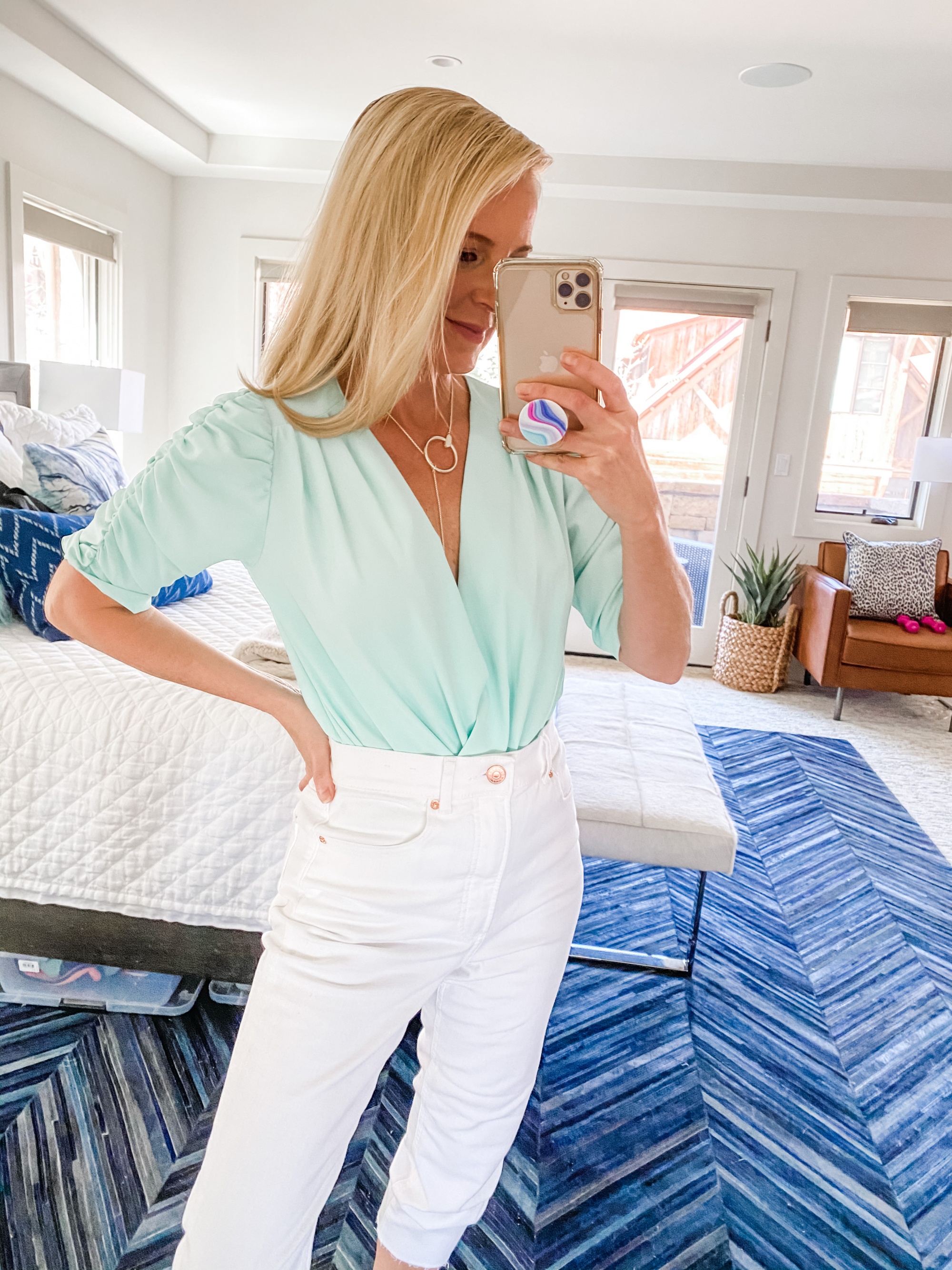 mint green wrap front Amanda Uprichard bodysuit spring outfit with white jeans on fashion blogger Busbee Style