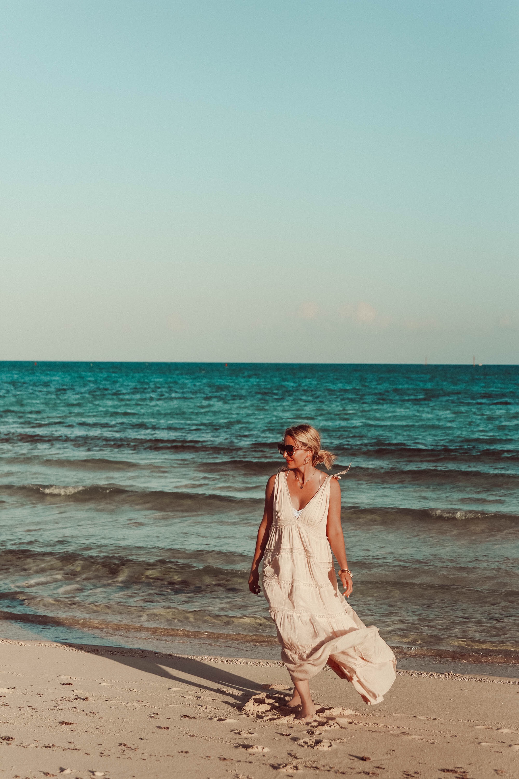 Maxi Dresses For Summer, Fashion blogger Erin Busbee of Busbee Style wearing a peach Free People Lily of the Valley maxi dress with a Free People lace bralette walking on the beach in the Bahamas