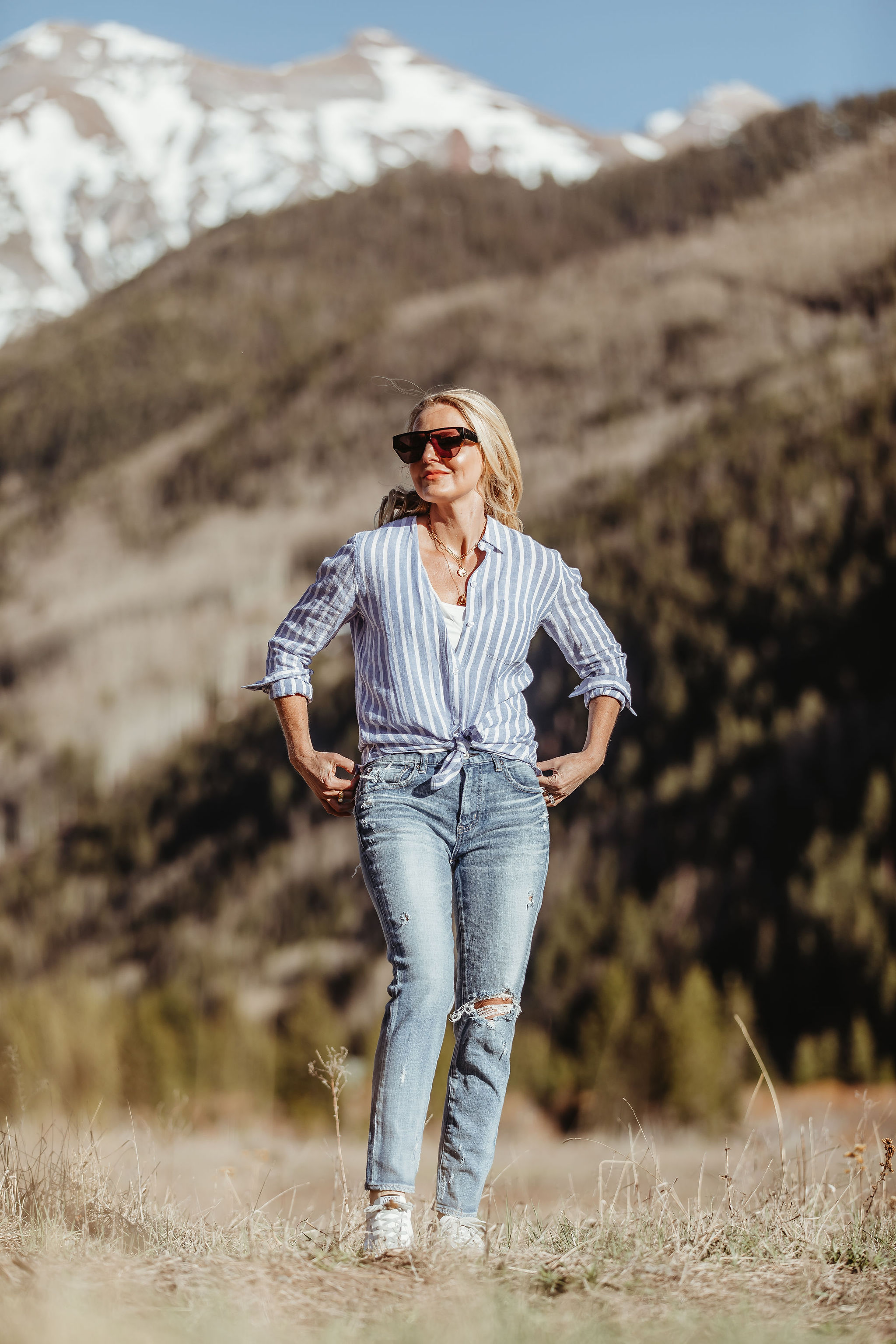 Lightweight Shirts For Summer, Fashion blogger Erin Busbee of BusbeeStyle.com wearing the striped Rails linen button down with Moussy Vintage tapered jeans and Golden Goose platform sneakers with white raw edge sleeveless undershirt from Nordstrom in Telluride, Colorado