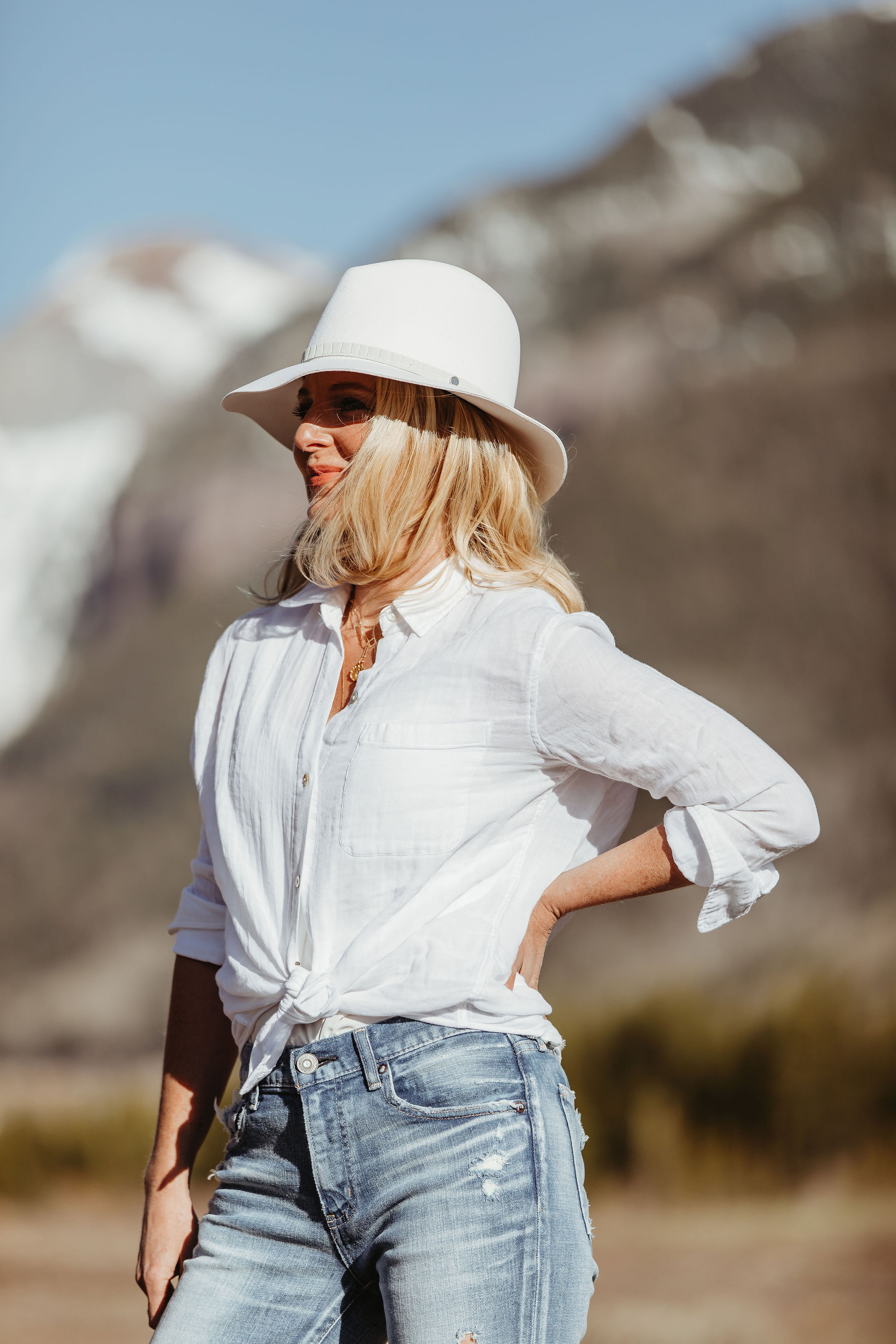 Button Downs For Summer, Fashion blogger Erin Busbee of BusbeeStyle.com wearing the white cotton Rails Ellis shirt with Moussy Vintage tapered jeans and Golden Goose platform sneakers and white rag & bone hat from Nordstrom in Telluride, Colorado