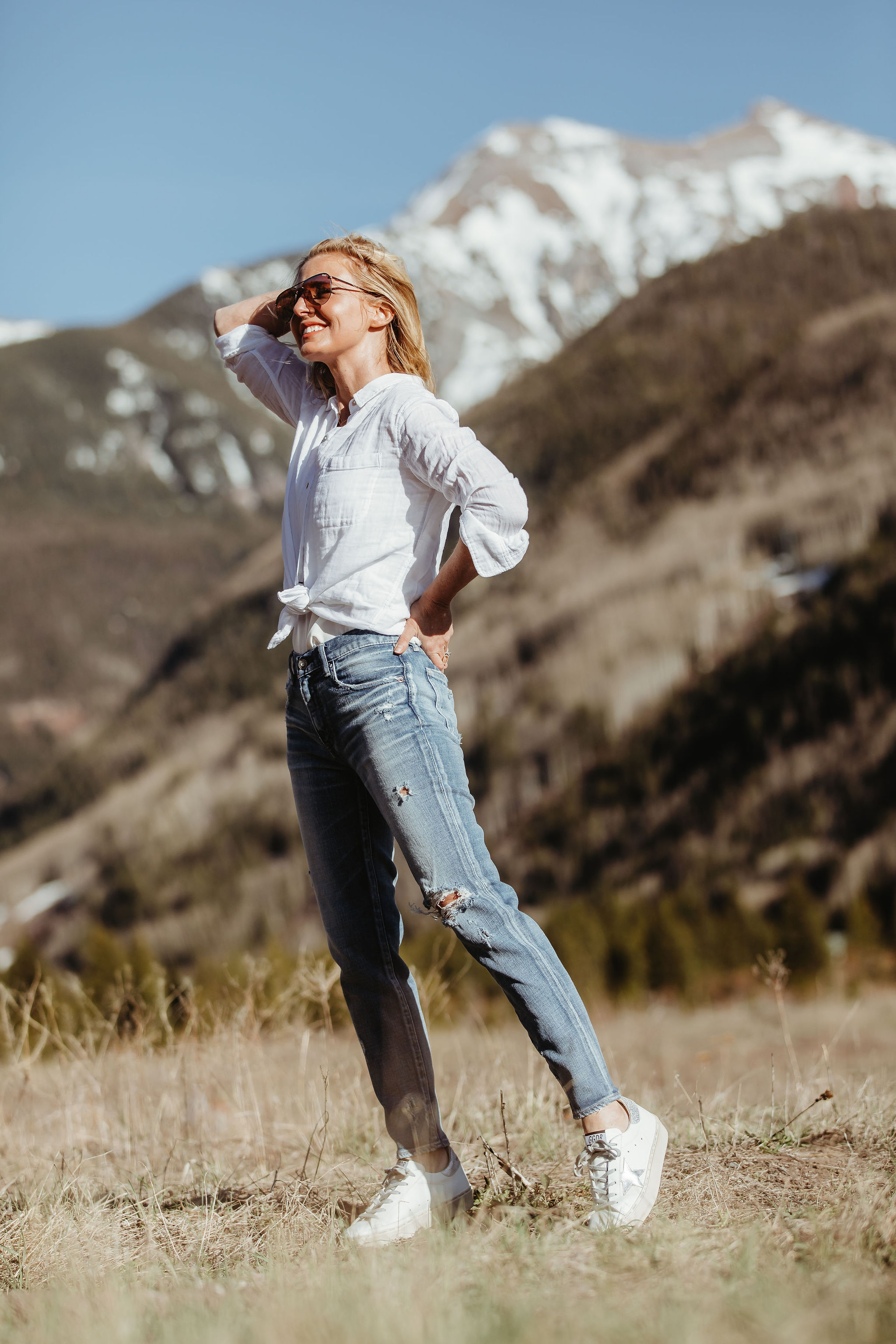 Lightweight Shirts For Summer, Fashion blogger Erin Busbee of BusbeeStyle.com wearing the white cotton Rails Ellis shirt with Moussy Vintage tapered jeans and Golden Goose platform sneakers from Nordstrom in Telluride, Colorado