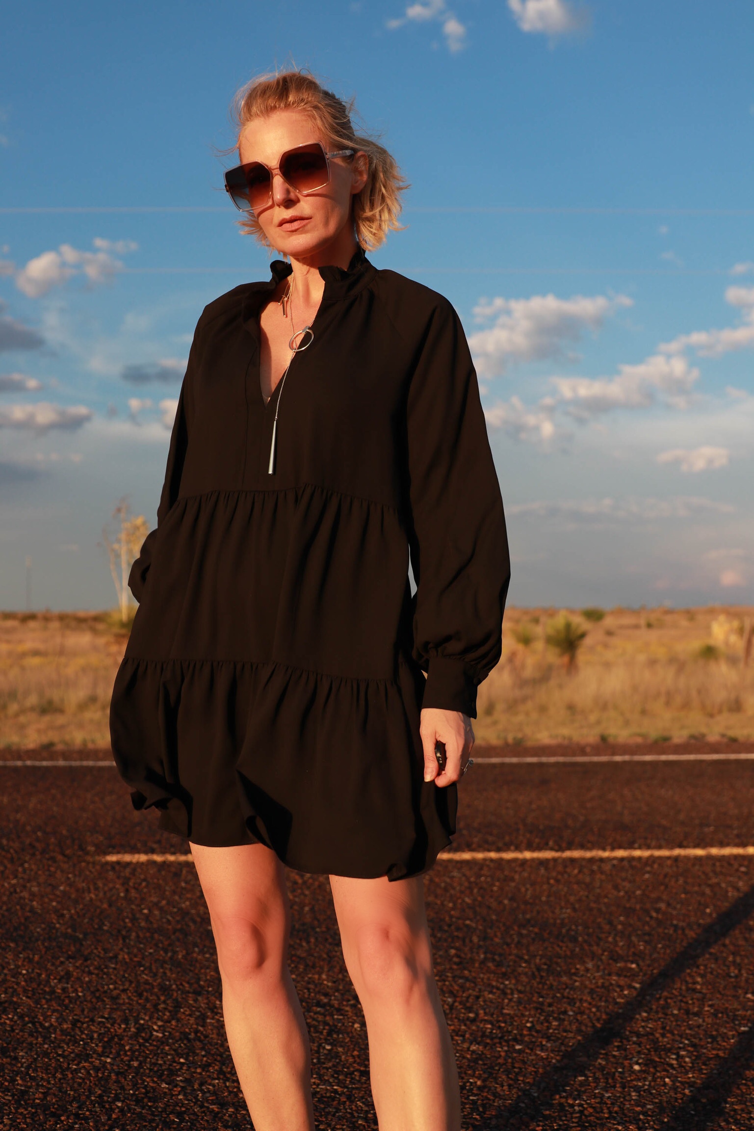 Dress For Summer, Fashion blogger Erin Busbee of Busbee Style wearing a black long sleeve tiered Amanda Uprichard dress with a Kendra Scott adjustable necklace, Saint Laurent sunglasses, and Valentino sandals in south Texas