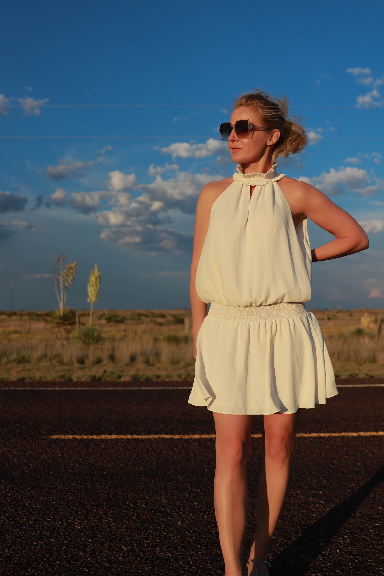 Dress For Summer, Fashion blogger Erin Busbee of Busbee Style wearing a white smocked waist high neck dress by Amanda Uprichard dress with a Julie Vos cuff bracelet, Saint Laurent sunglasses, and Valentino sandals in south Texas