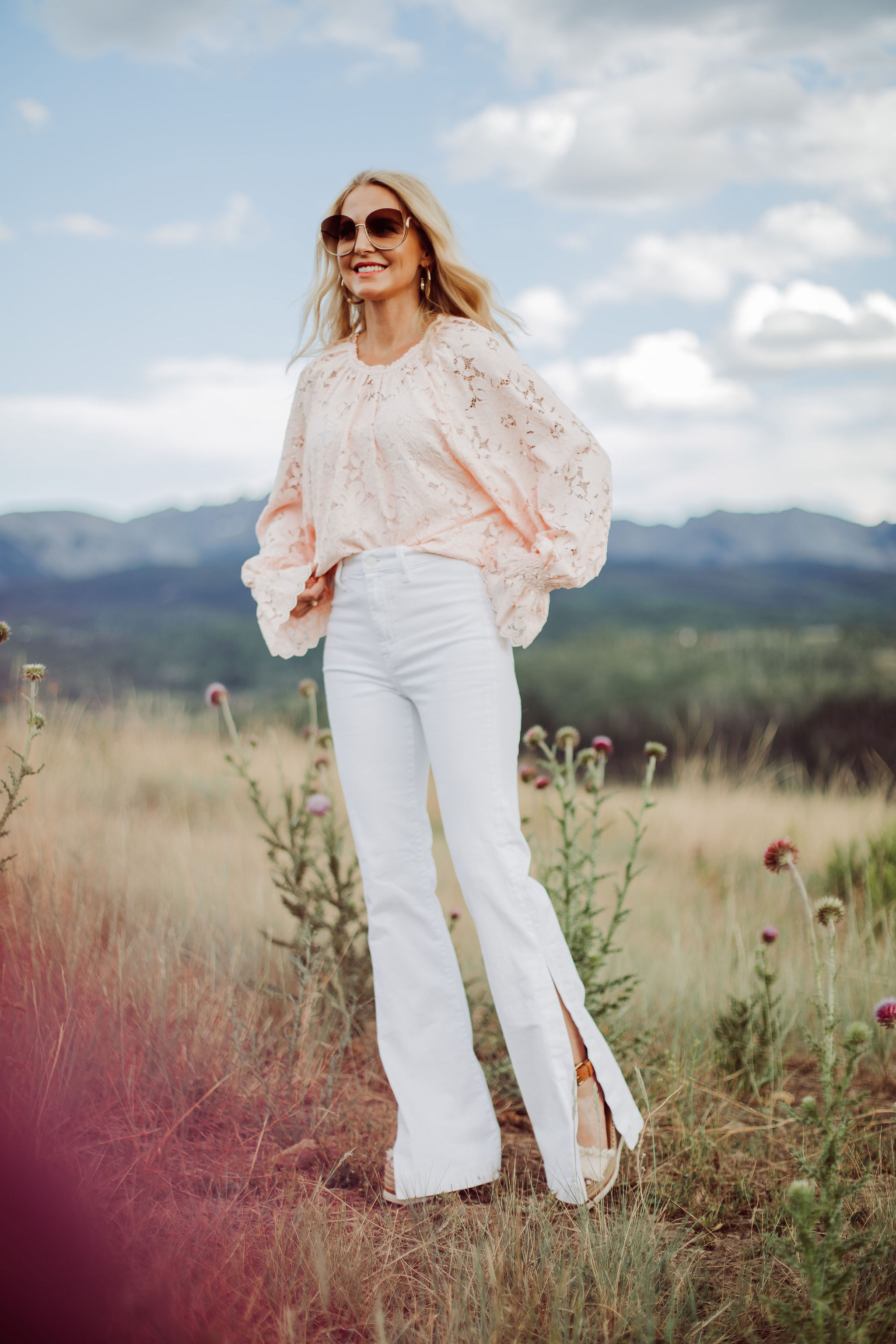 White Jeans for women Over 40, Fashion blogger Busbee Style wearing white 7 For All Mankind split hem jeans, See by Chloe espadrille wedges, pink lace long sleeve Free People top in Telluride, Colorado