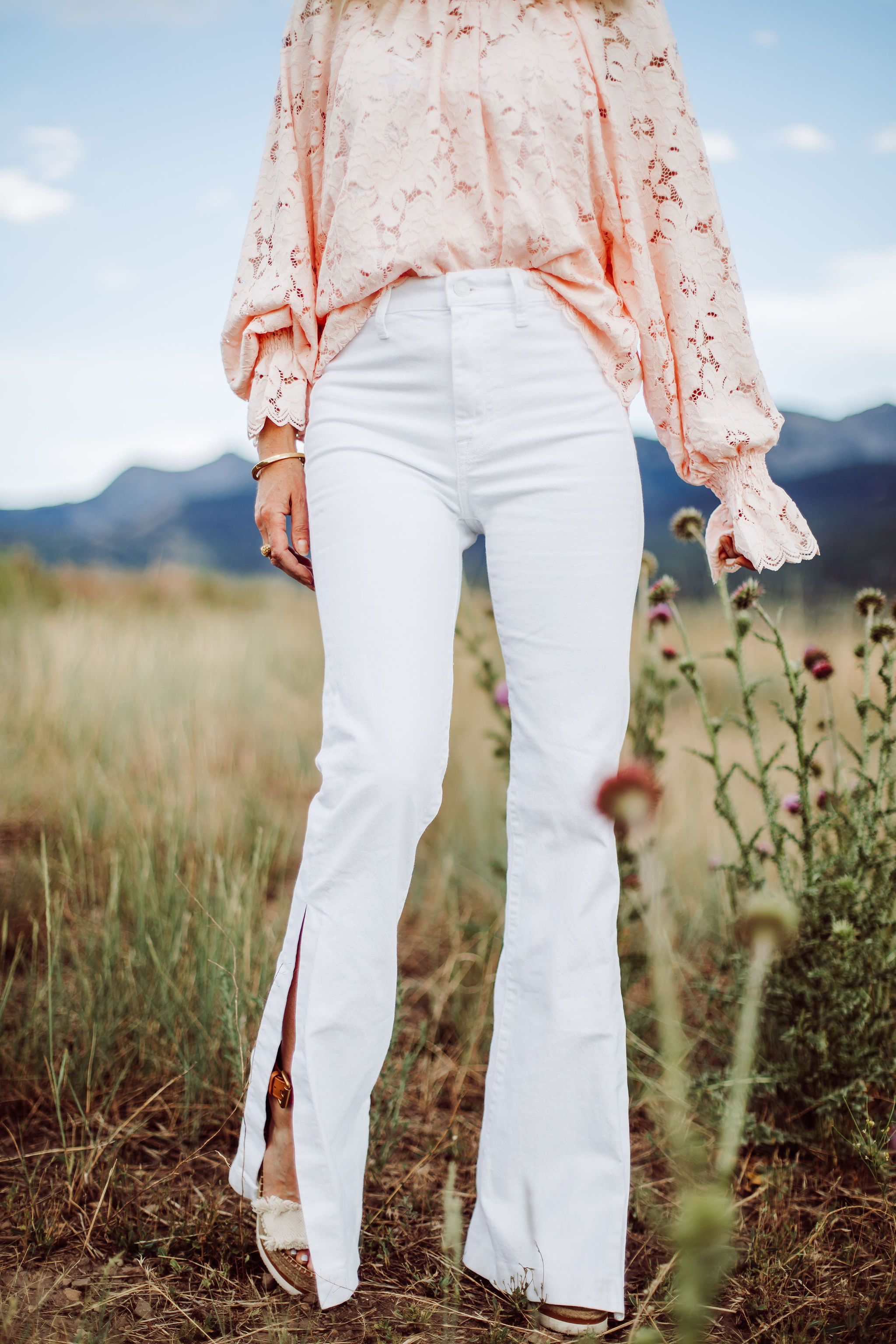 White Jeans Over 40, Fashion blogger Erin Busbee of Busbee Style wearing white 7 For All Mankind split hem jeans with See by Chloe espadrille wedges and pink lace long sleeve Free People top in Telluride, Colorado