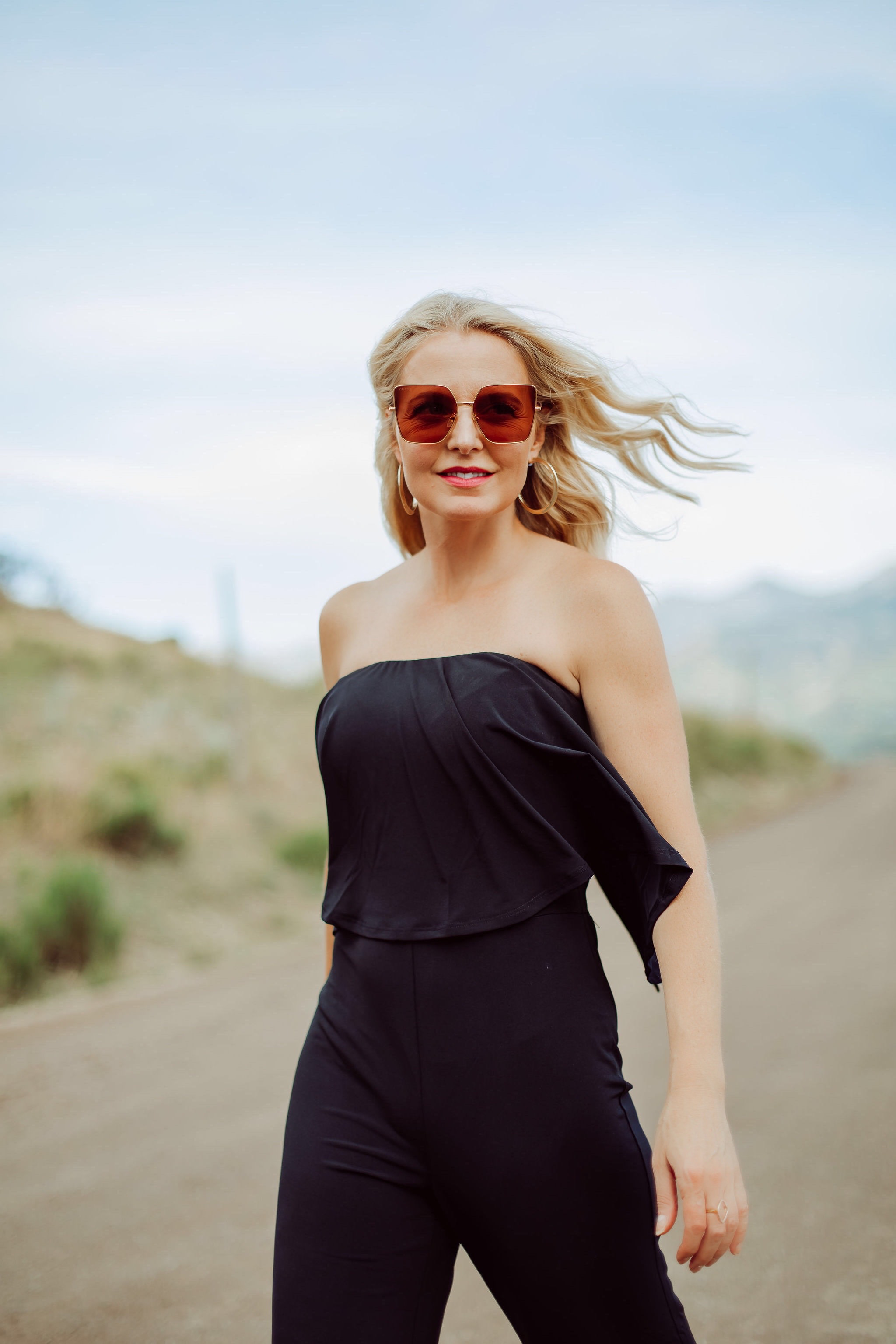 Jumpsuits Over 40, Fashion Blogger Erin Busbee of Busbee Style wearing a black flared jumpsuit by Scoop with flounce top and black strappy block heel sandals by Scoop from Walmart in Telluride, Colorado