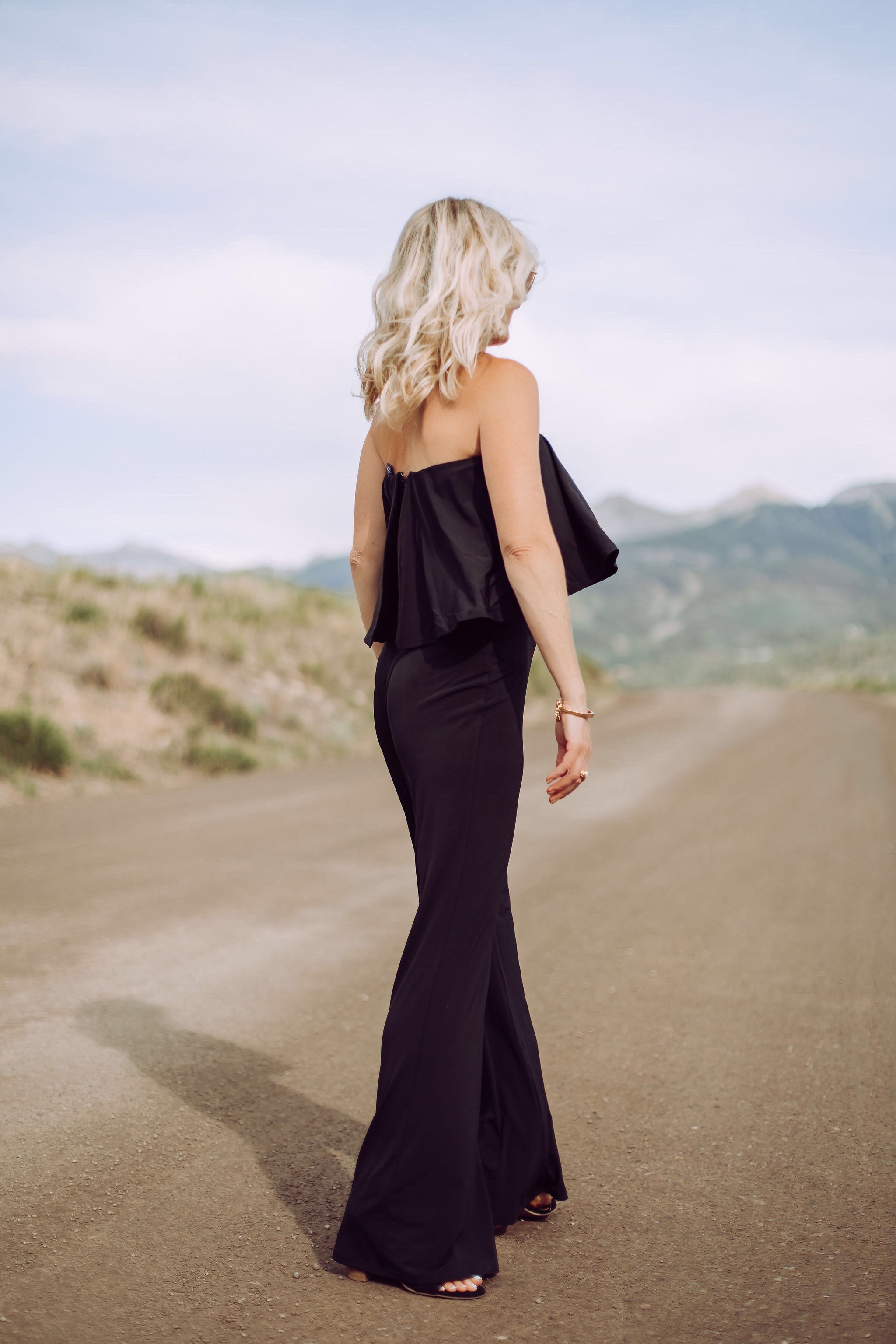 Jumpsuits Over 40, Fashion Blogger Erin Busbee of Busbee Style wearing a black flared jumpsuit by Scoop and black strappy block heel sandals by Scoop from Walmart walking in Telluride, Colorado